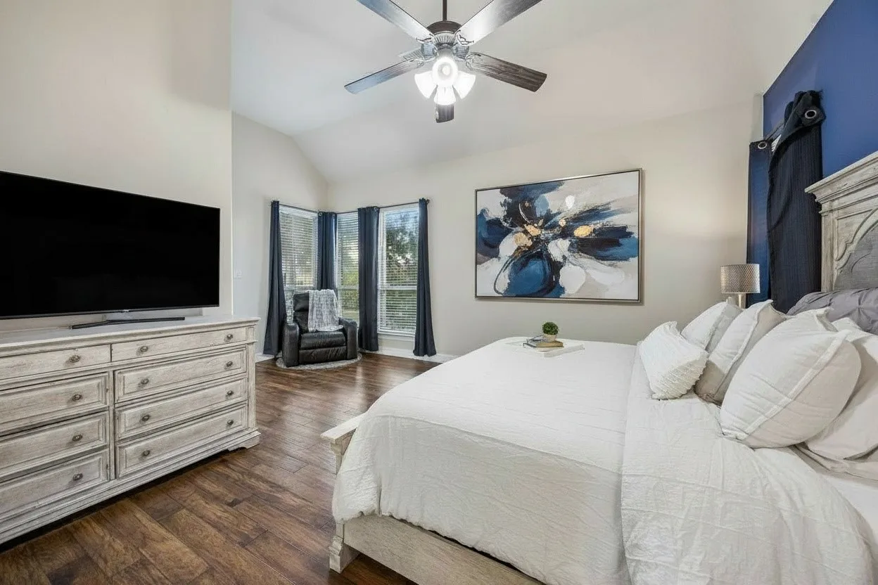 Alternate view of the first-floor primary suite highlights the room's generous size and natural light.