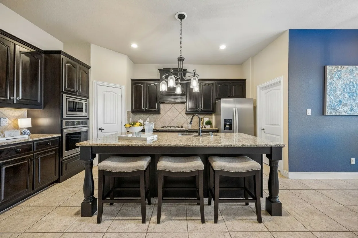 Kitchen island provides additional prep space and seating while keeping the kitchen connected to the main living areas.