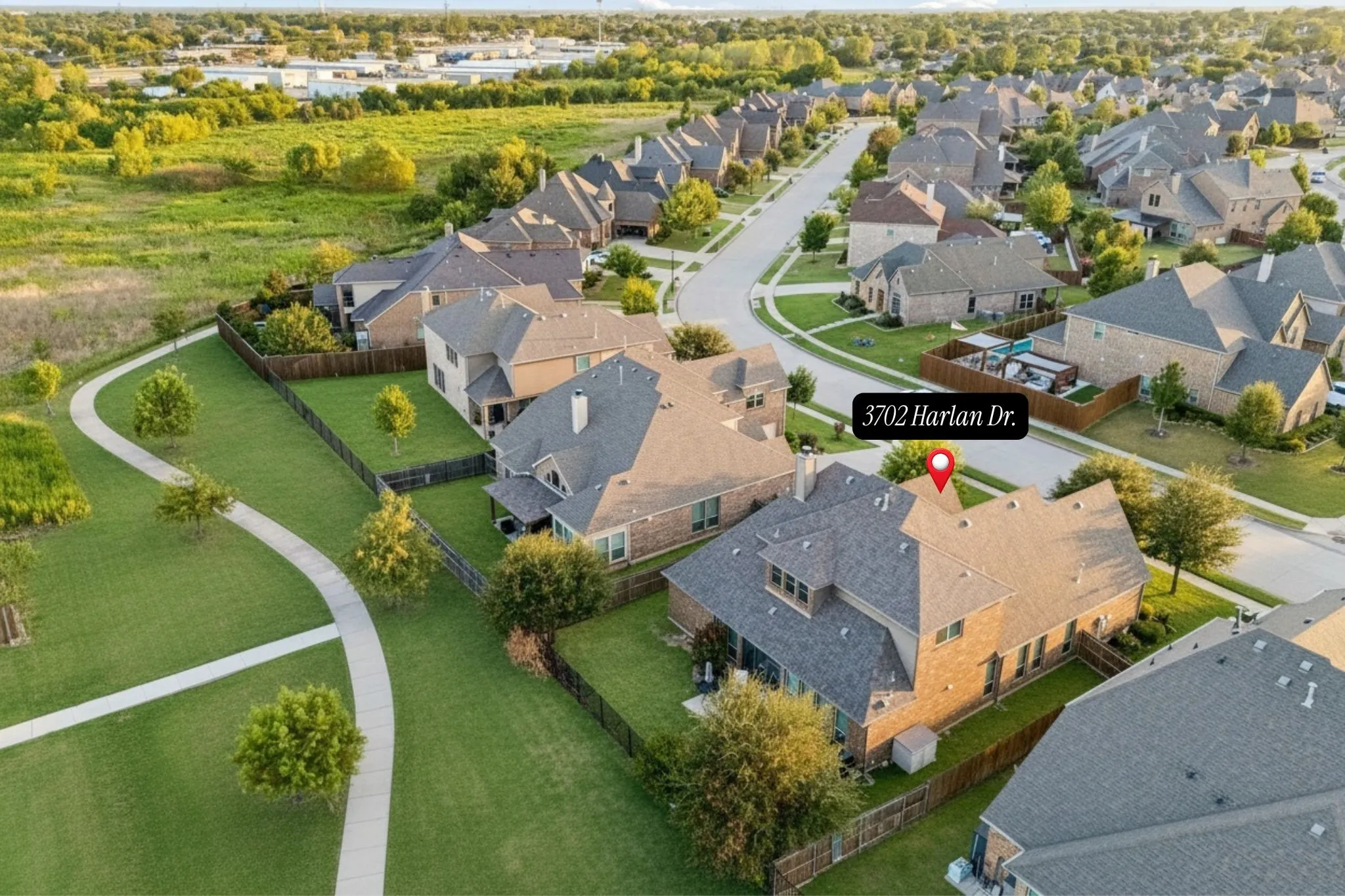 Elevated view highlights the greenbelt corridor directly behind the home and its connection to the surrounding community.