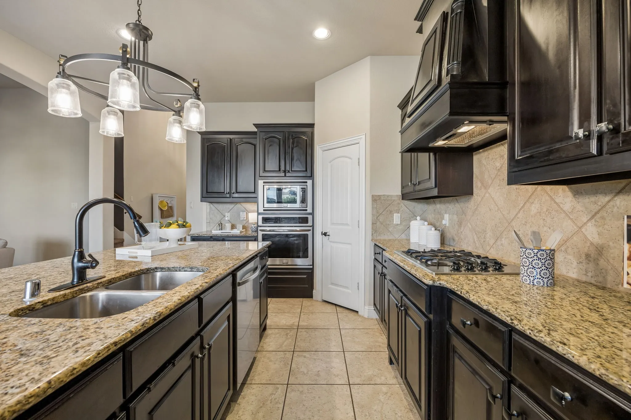 Granite countertops, stainless steel appliances, espresso cabinetry and updated lighting complete the kitchen.