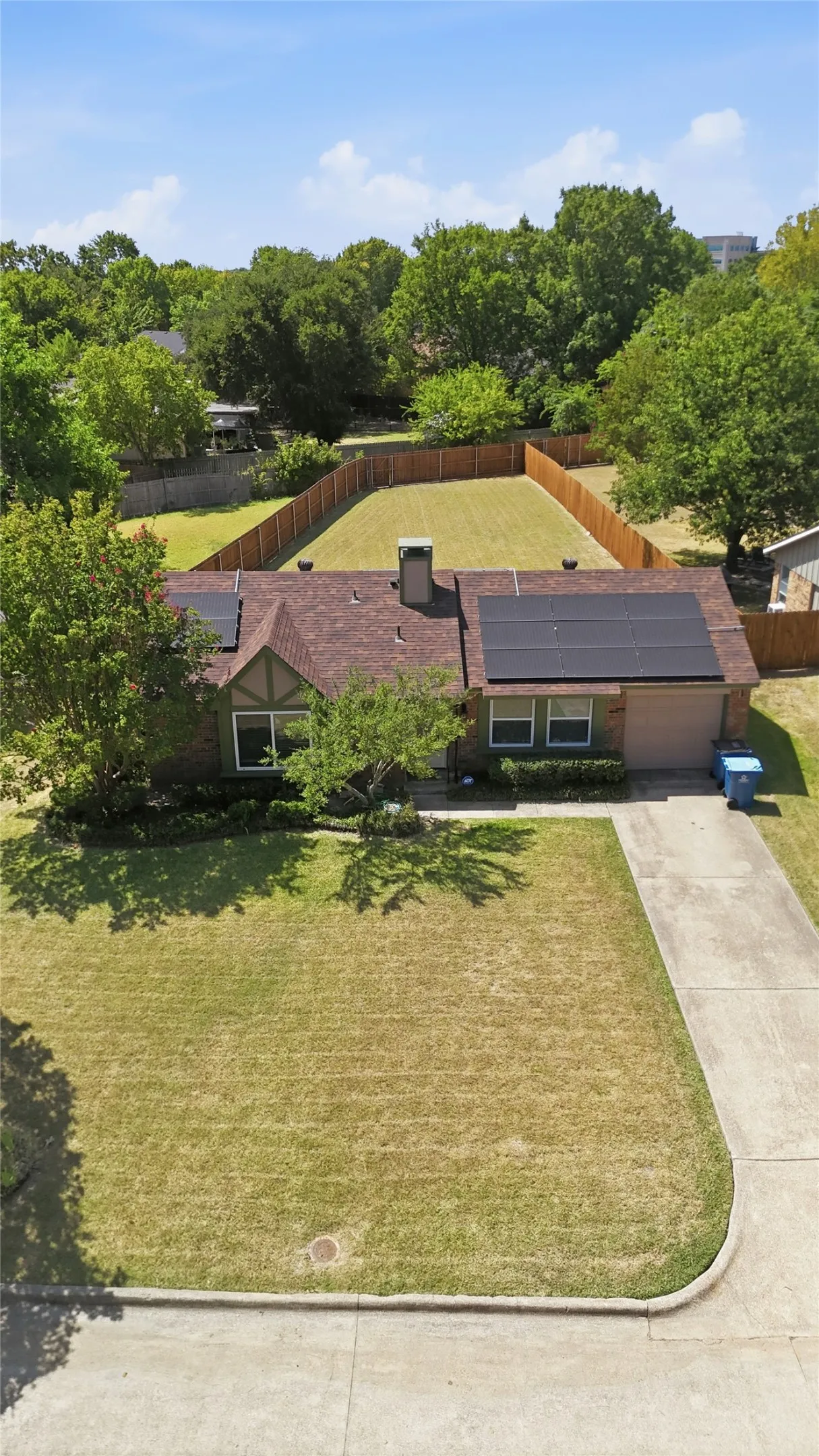 Brick exterior residence with a shingle roof