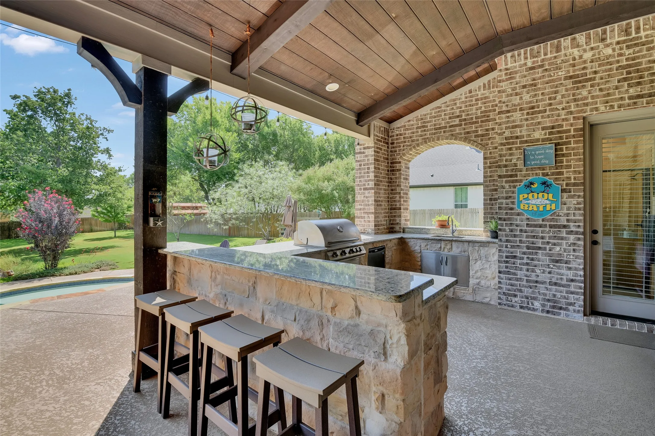 The seller says the opening in the brick on the South end there, allows breeze to carry away any smoke from the grill at the outdoor kitchen.