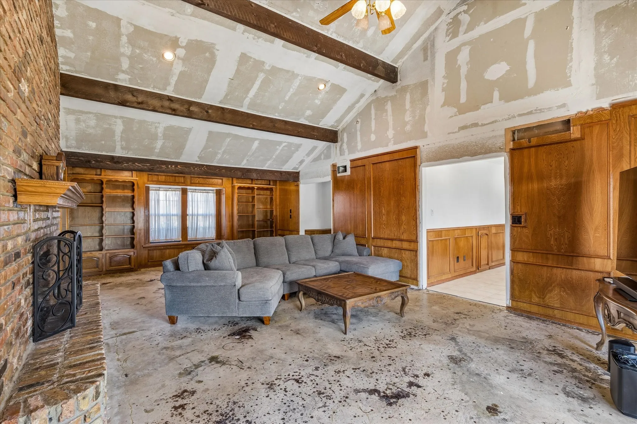 Large living space, flooring is in the garage just needs to be installed. Popcorn has already been removed from the ceiling. Lovely beams
