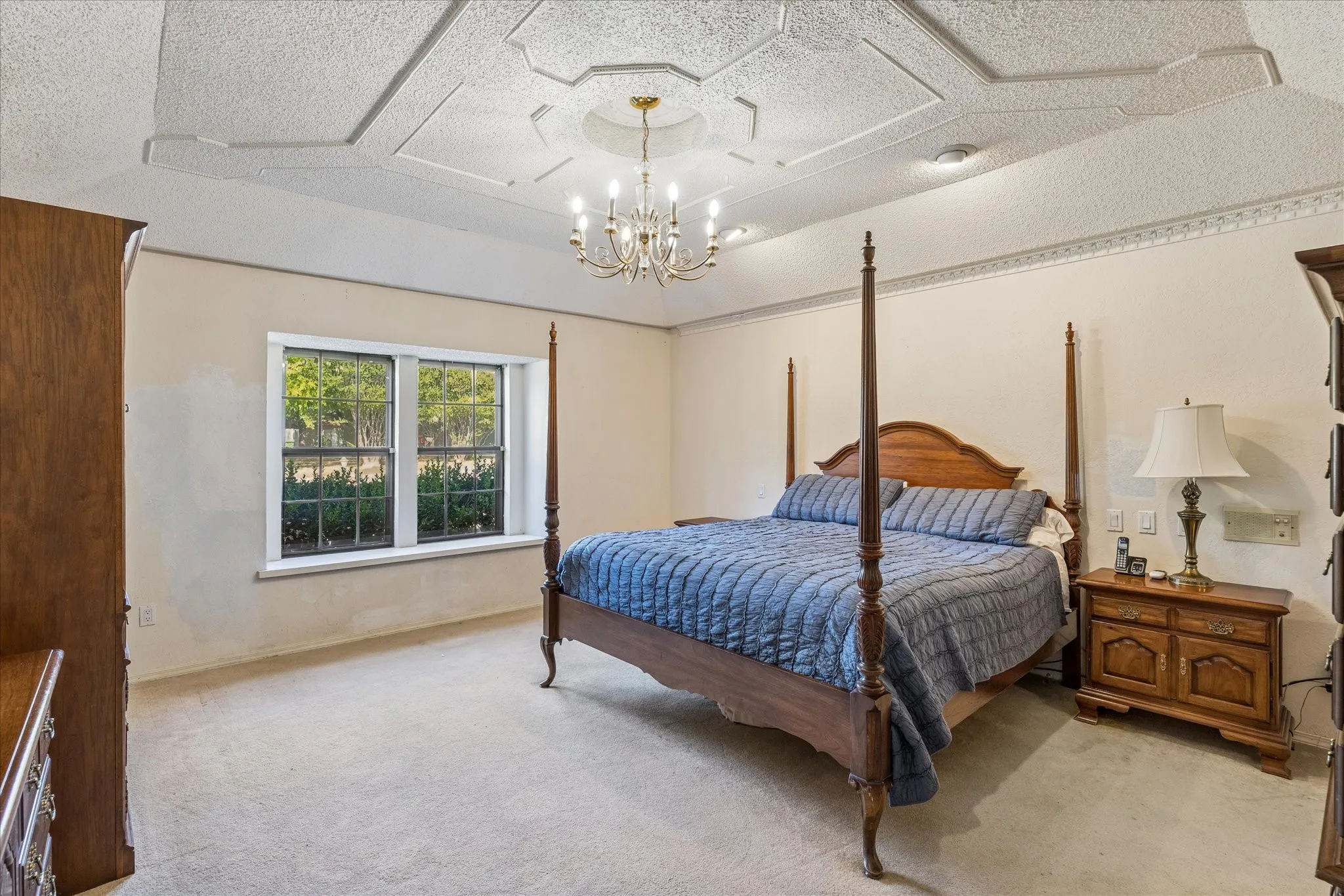 Large primary bedroom with gorgeous ceiling details.