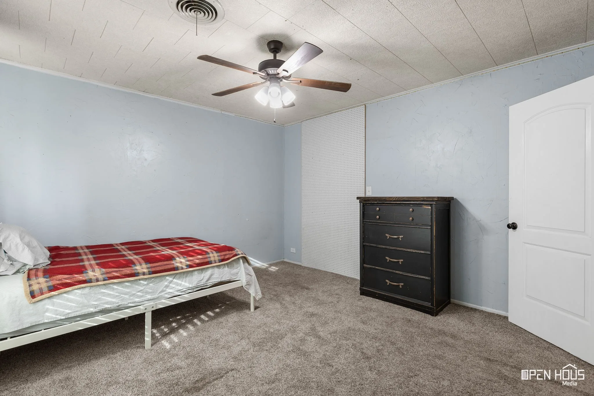 Neutral tone wall covering with contrasting trim details, textured ceiling, and a ceiling fan with integrated lighting