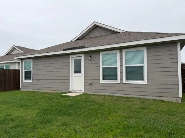 Exterior with horizontal siding, multiple windows, and a rear door