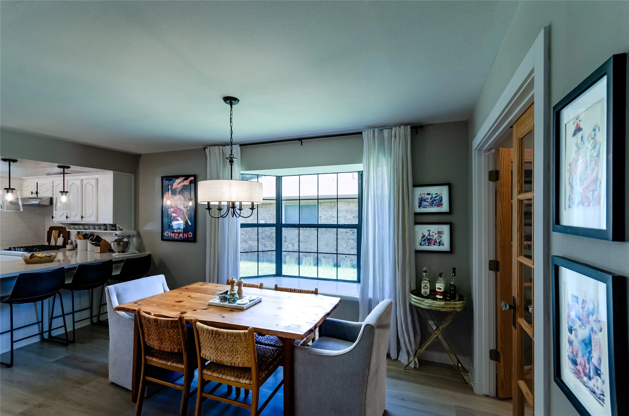 Open concept dining area with wood-finish flooring