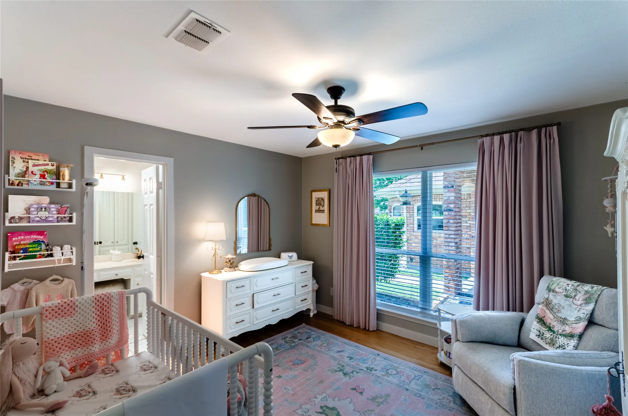Recessed lighting, ceiling fan with integrated light, wood-finish flooring, window with blinds, and an open doorway to a bathroom with a dual vanity