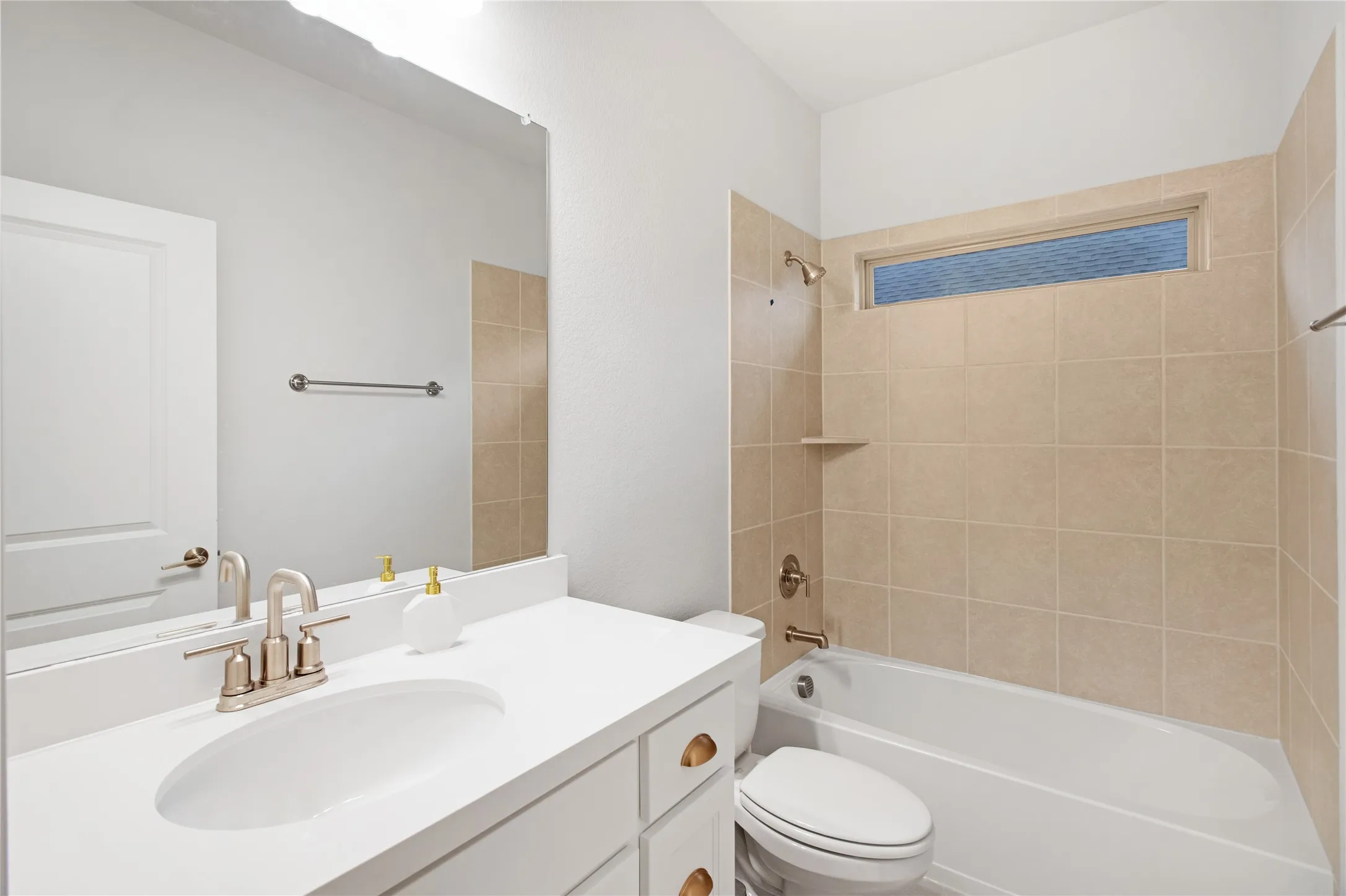 Vanity with integrated sink, brushed nickel faucet, and white cabinetry