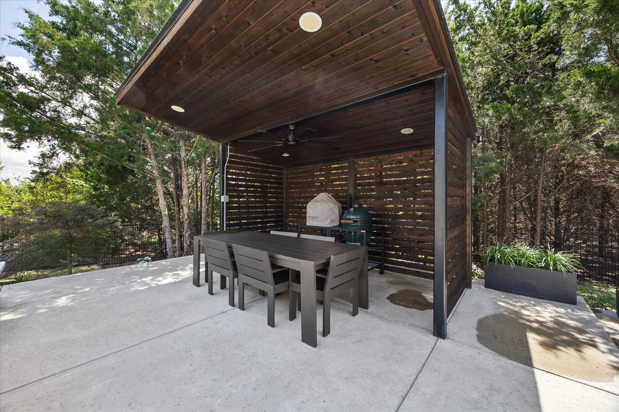 Covered outdoor living space featuring a wood-panel ceiling, recessed lighting, and a built-in outdoor fan
