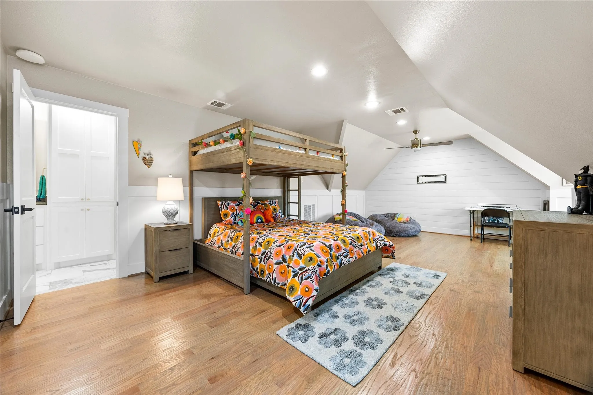 Hardwood flooring throughout, recessed lighting, built-in cabinetry, sloped ceiling, and ceiling fan