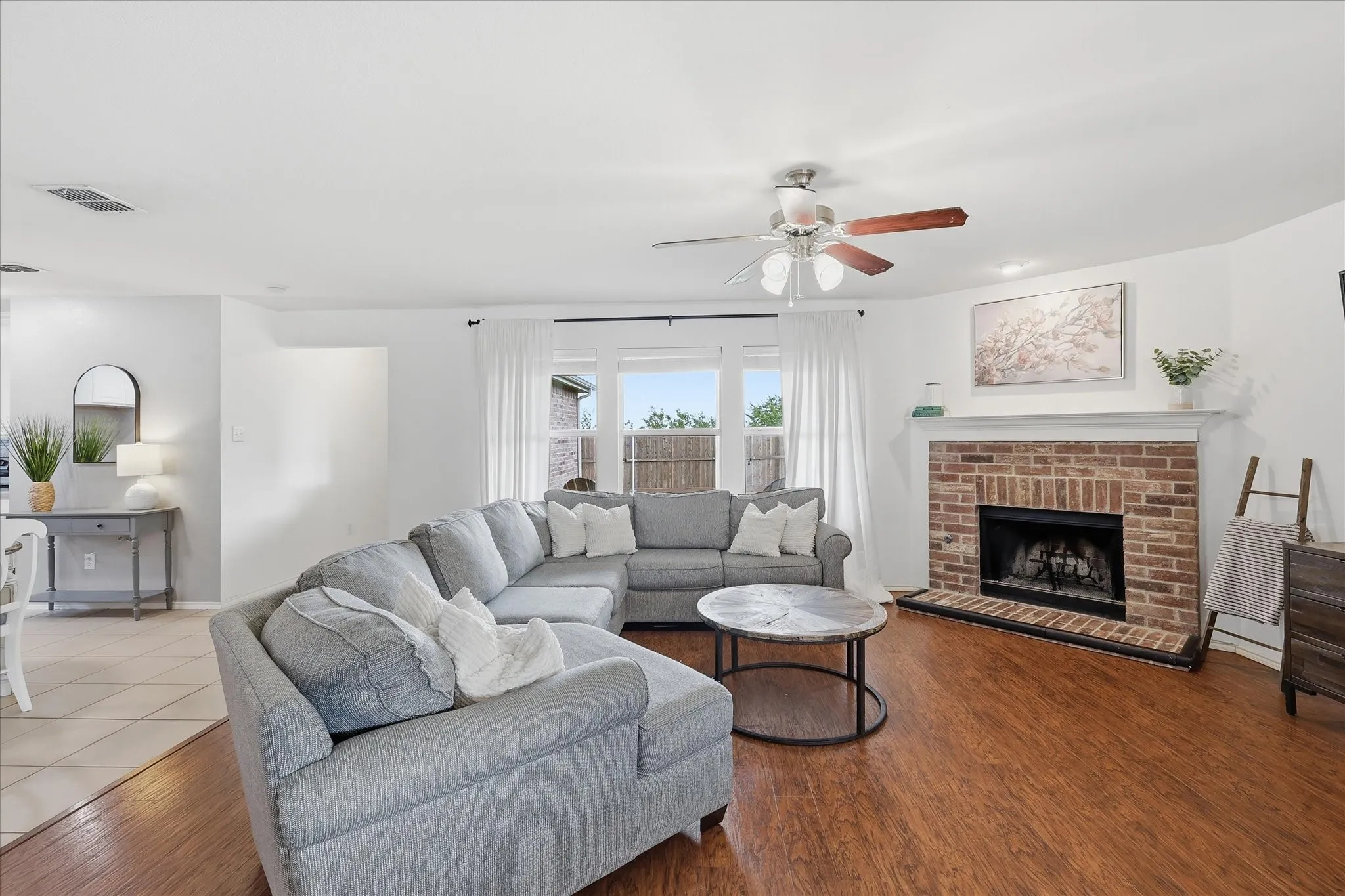 Spacious living room with gas fireplace and views to the expansive backyard
