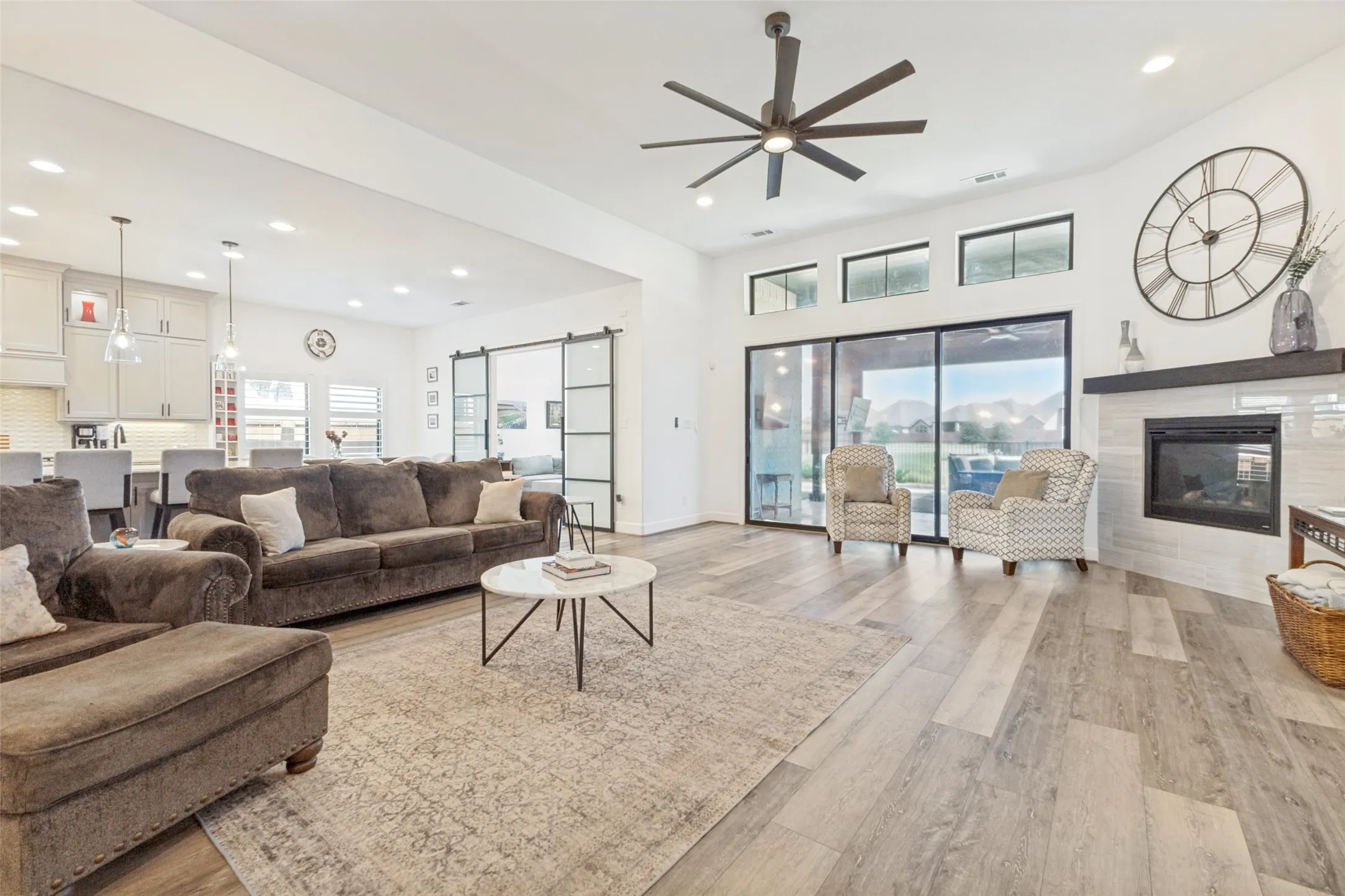 Wood-finish flooring throughout, with a built-in fireplace featuring a tile surround and dark wood mantel