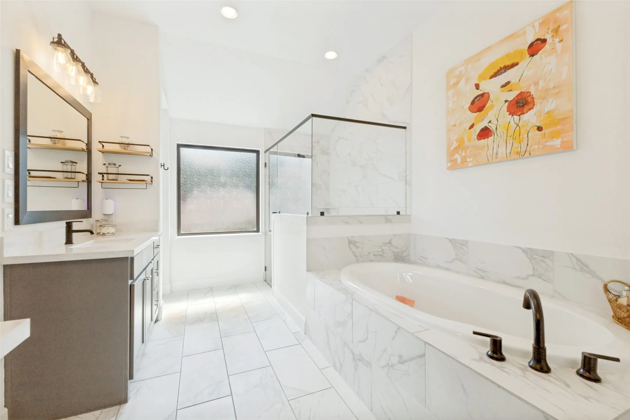 Freestanding soaking tub with dark bronze fixtures, glass-enclosed shower, single vanity with dark bronze faucet, framed mirror, and tile flooring