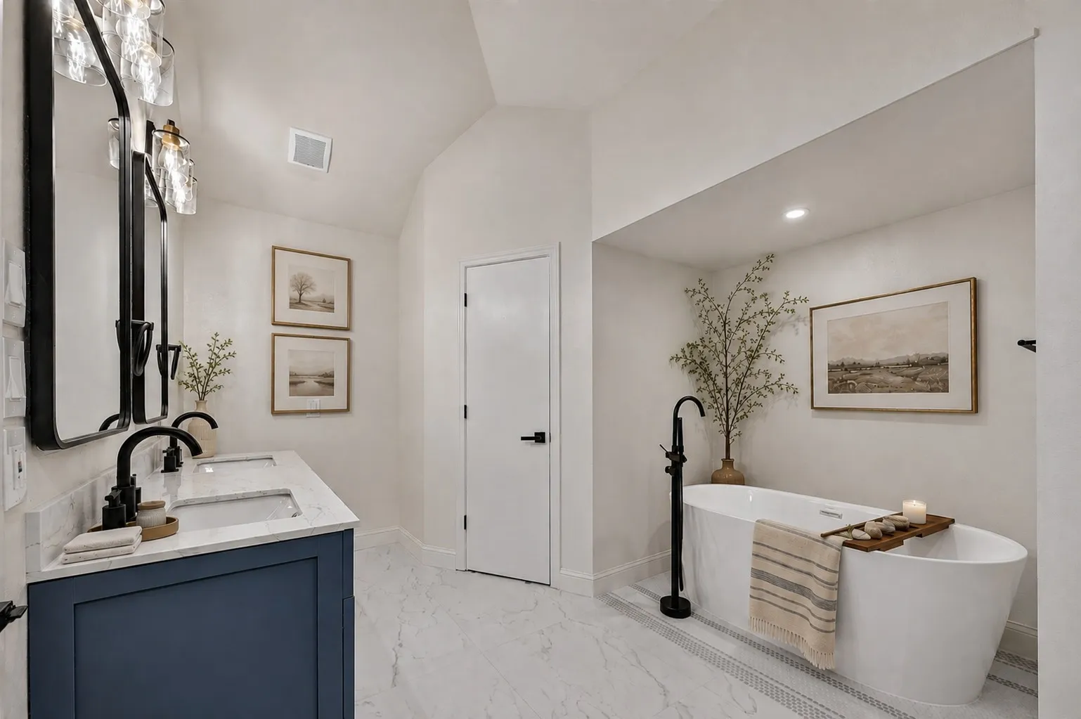 Vaulted ceiling, dual vanity with undermount sinks, freestanding soaking tub, matte black fixtures, and marble-look tile flooring