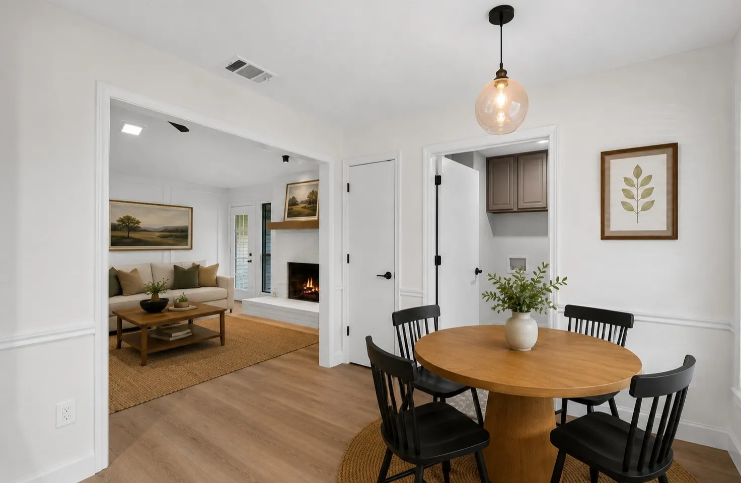 Wood-finish flooring, wainscoting, and a spherical pendant light fixture