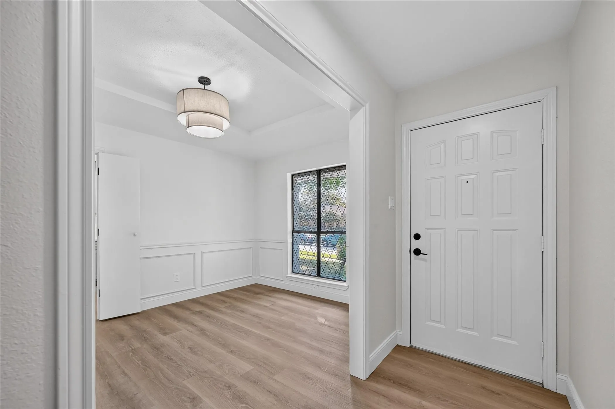 Entryway featuring a paneled door with black hardware
