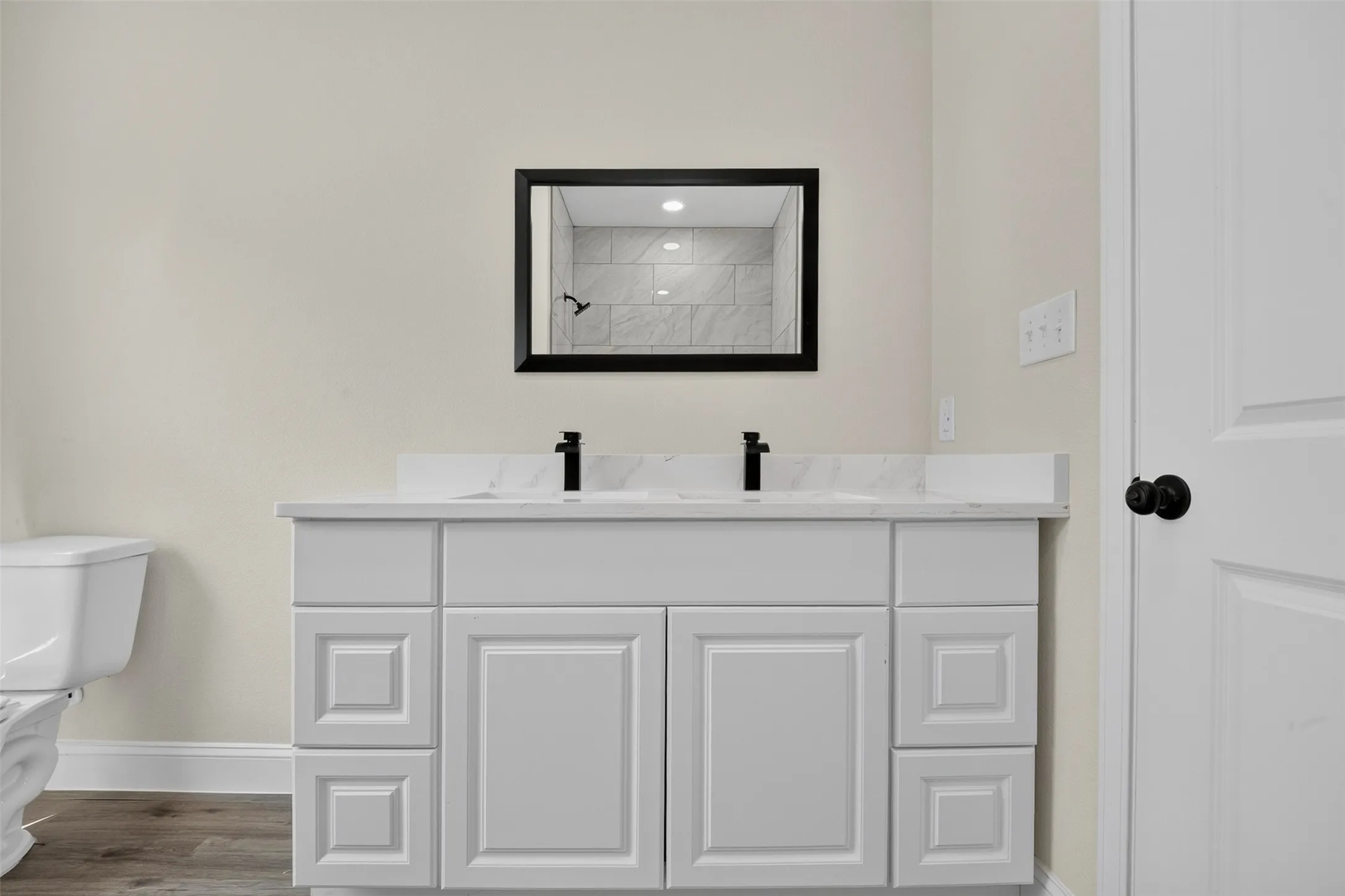 Dual vanity with stone-finish countertop, undermount sinks, and matte black fixtures