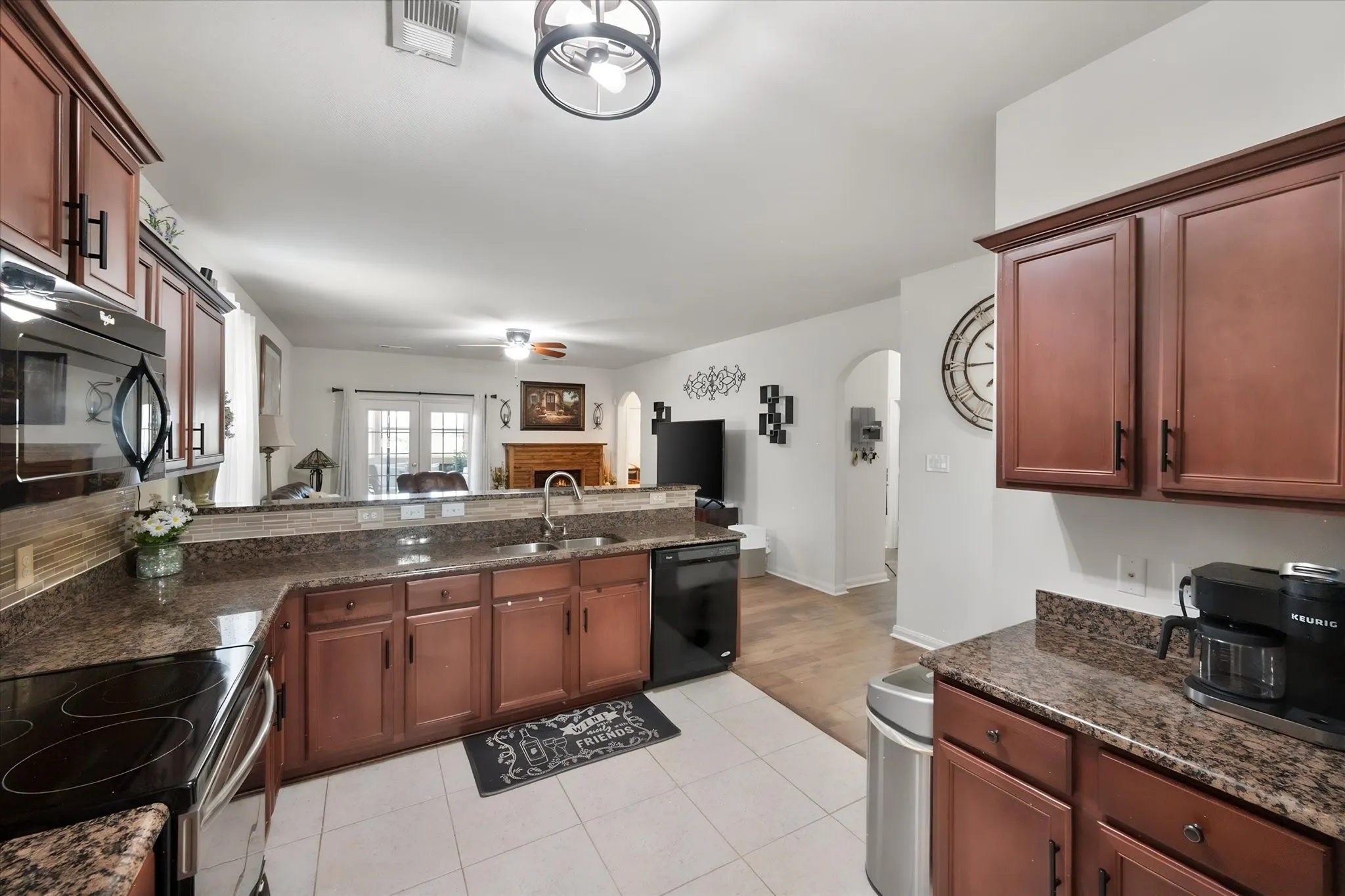 Kitchen featuring wood cabinetry, tile flooring, and stainless steel range.