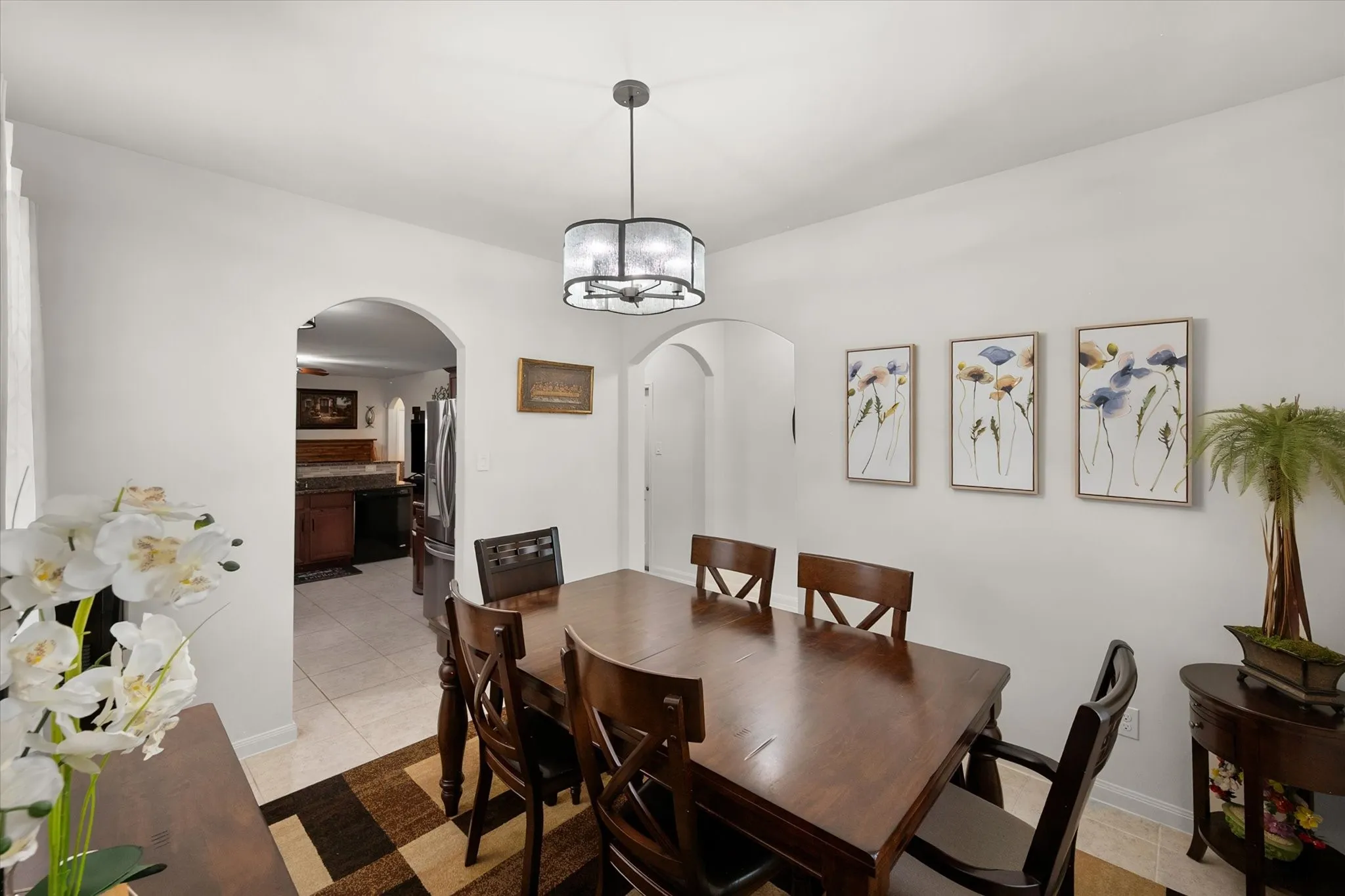 Neutral walls with arched doorways, recessed lighting, and a drum-style ceiling fixture