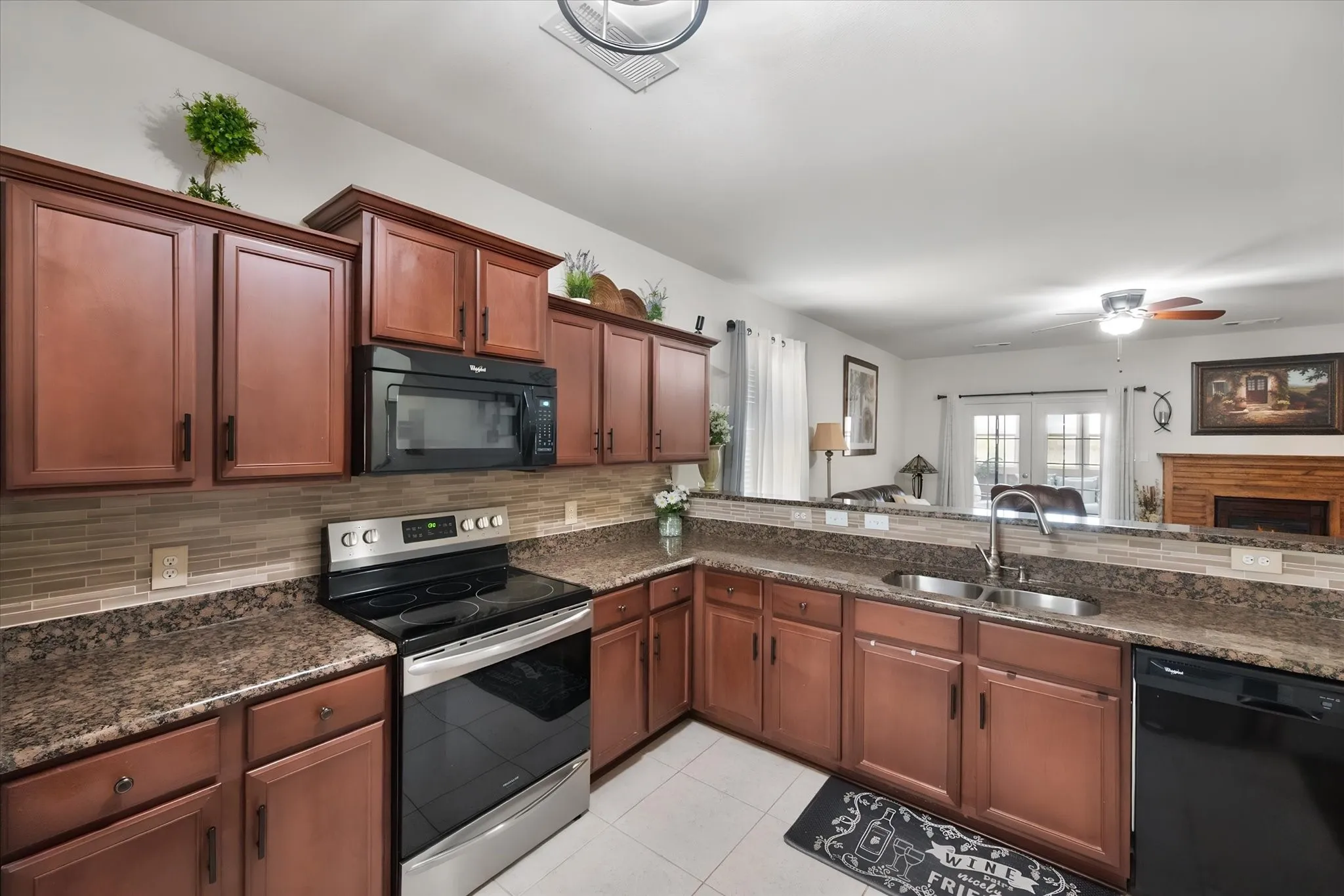 Kitchen featuring wood-finish cabinetry, a tiled backsplash, and  countertops