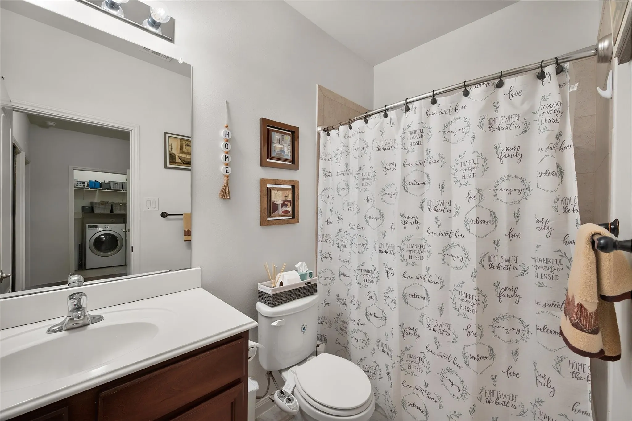 Bathroom featuring a single vanity with wood-finish cabinetry and a white countertop
