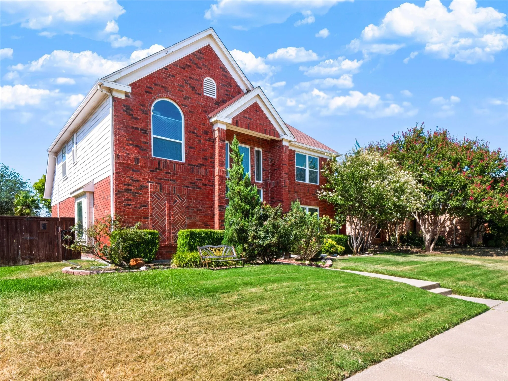 Red brick exterior with white siding accents