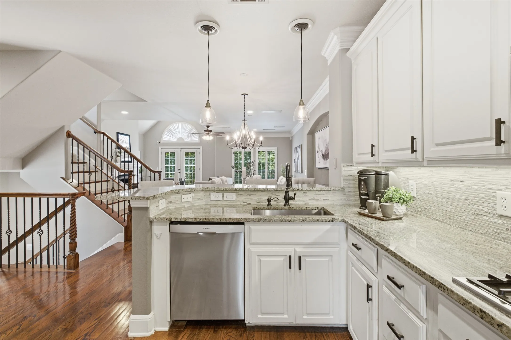 White cabinetry, stainless steel appliances, and a tile backsplash