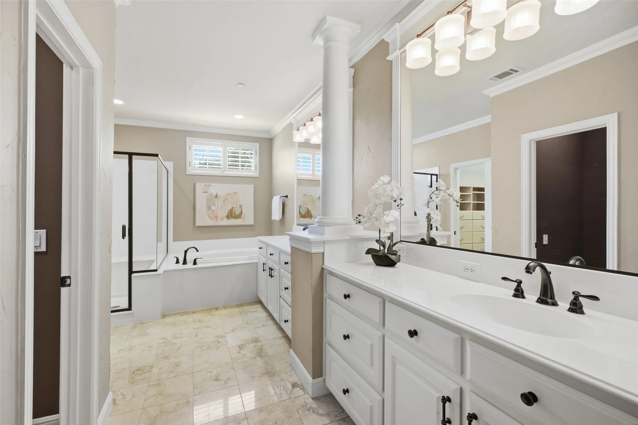 Dual vanity with white cabinetry, integrated sink, and dark bronze fixtures