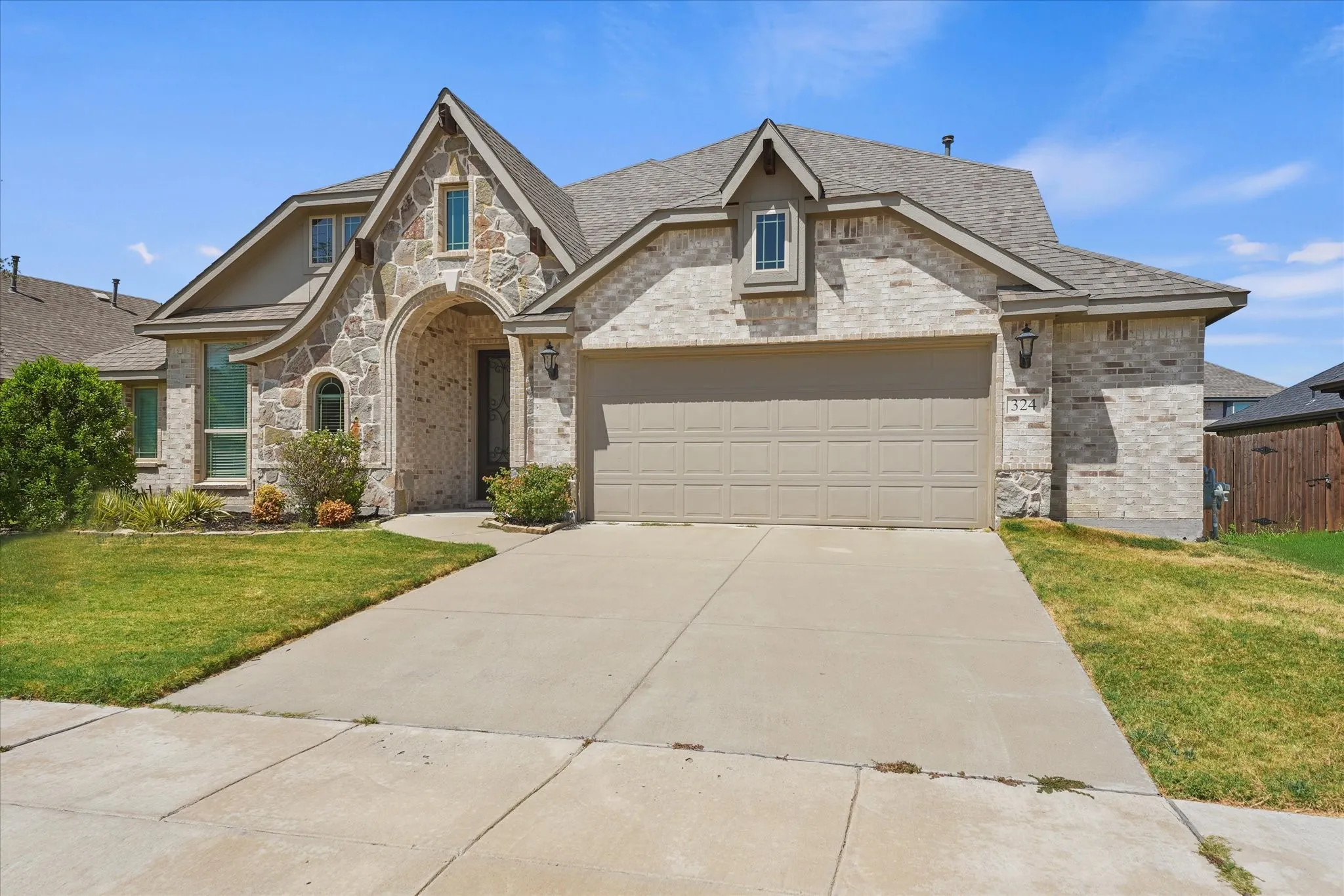 Stone and brick exterior with a front entry archway