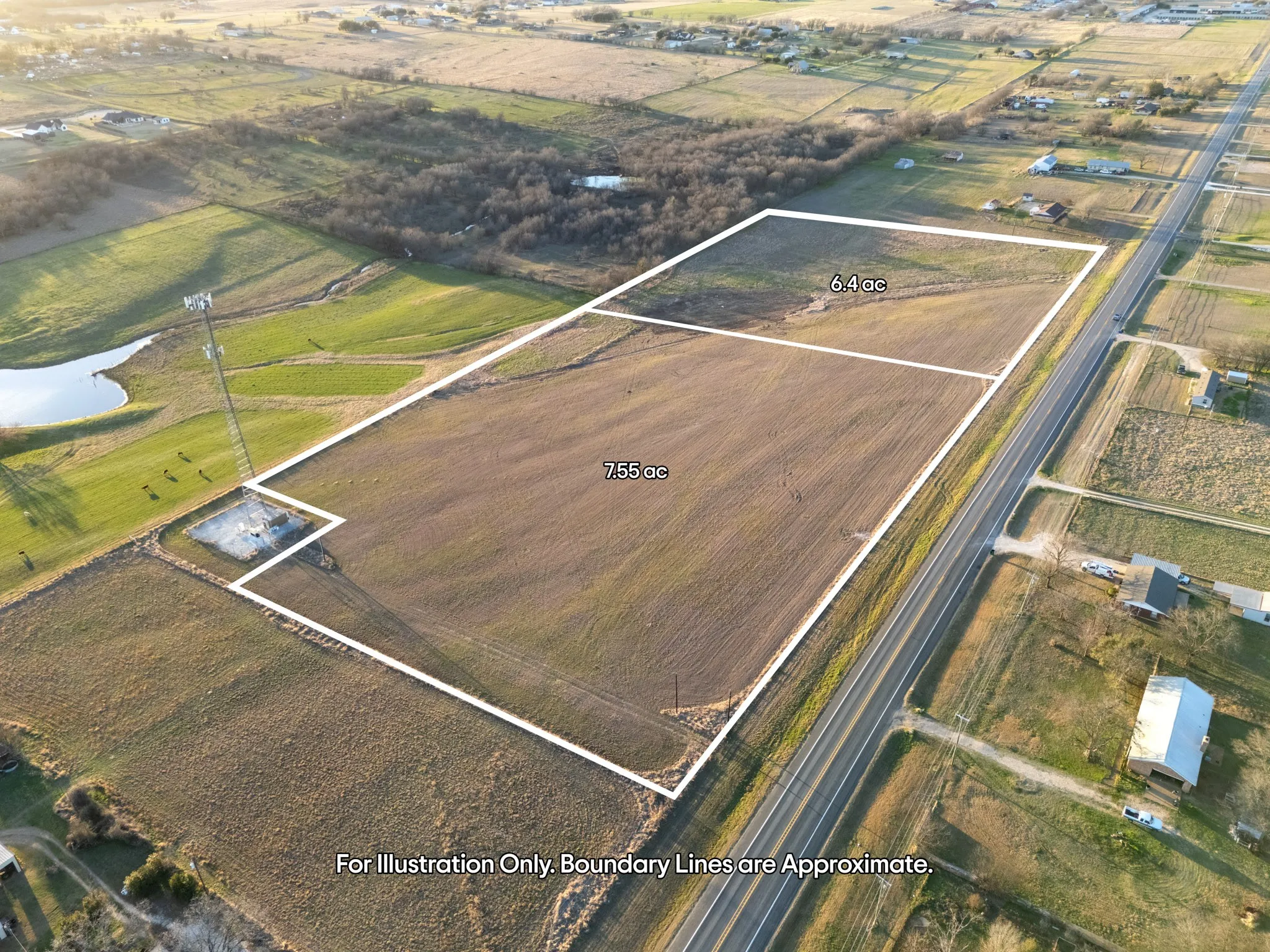 Expansive land parcel featuring open fields and adjacent highway access