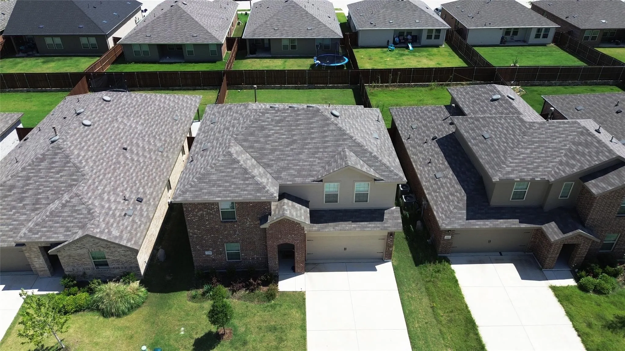 Two-story residence featuring a brick and siding exterior, an attached two-car garage, and a gabled roofline