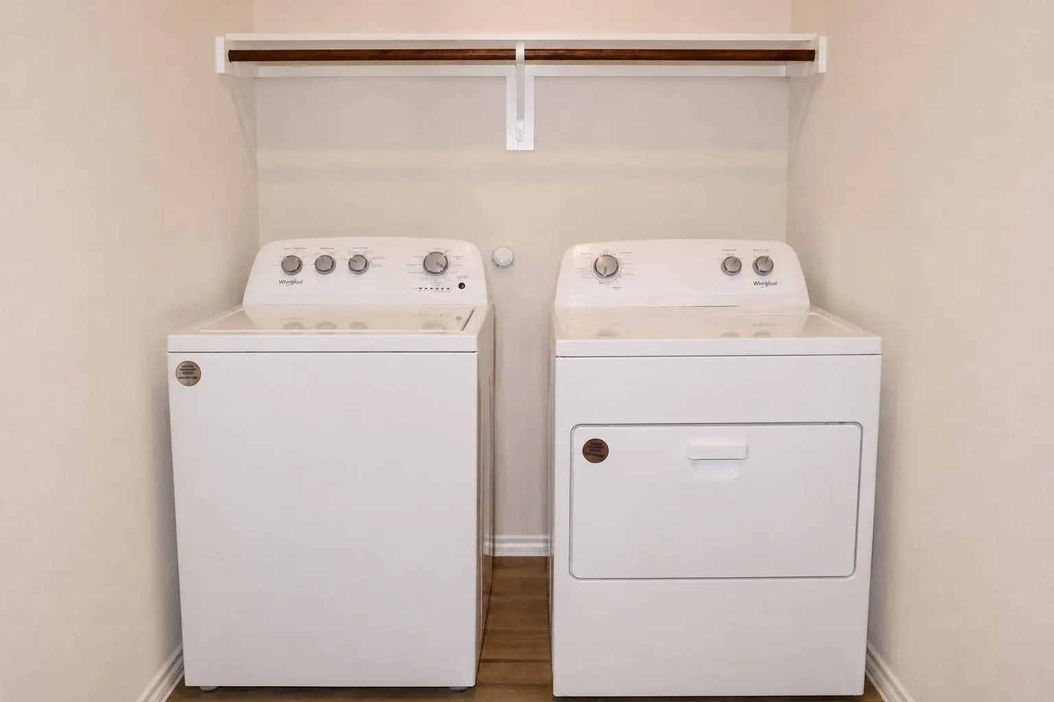 Dedicated laundry area with a white top-load washer and a white front-load dryer