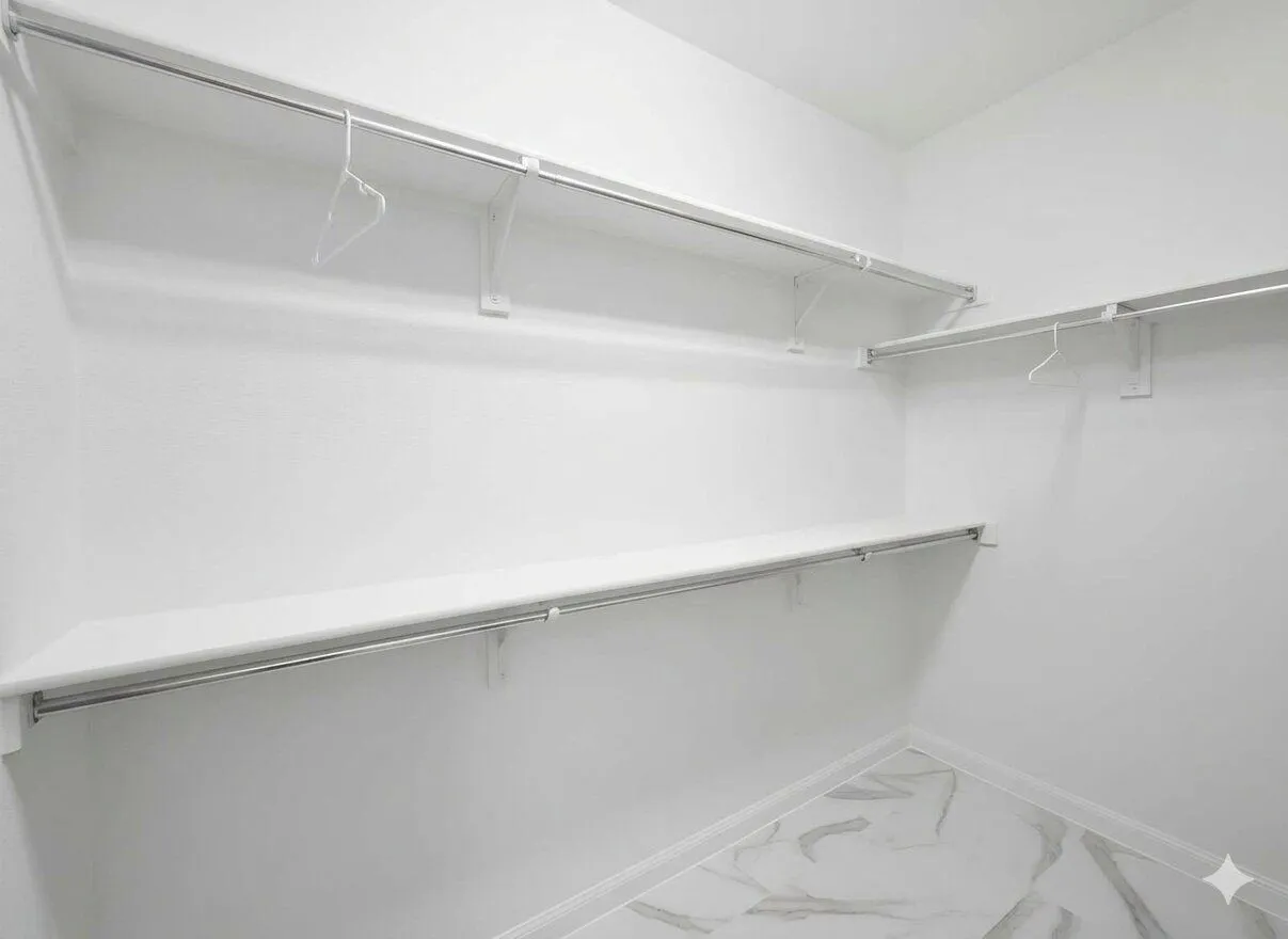Customizable closet system with multiple shelving units and hanging rods, featuring white walls and tile flooring