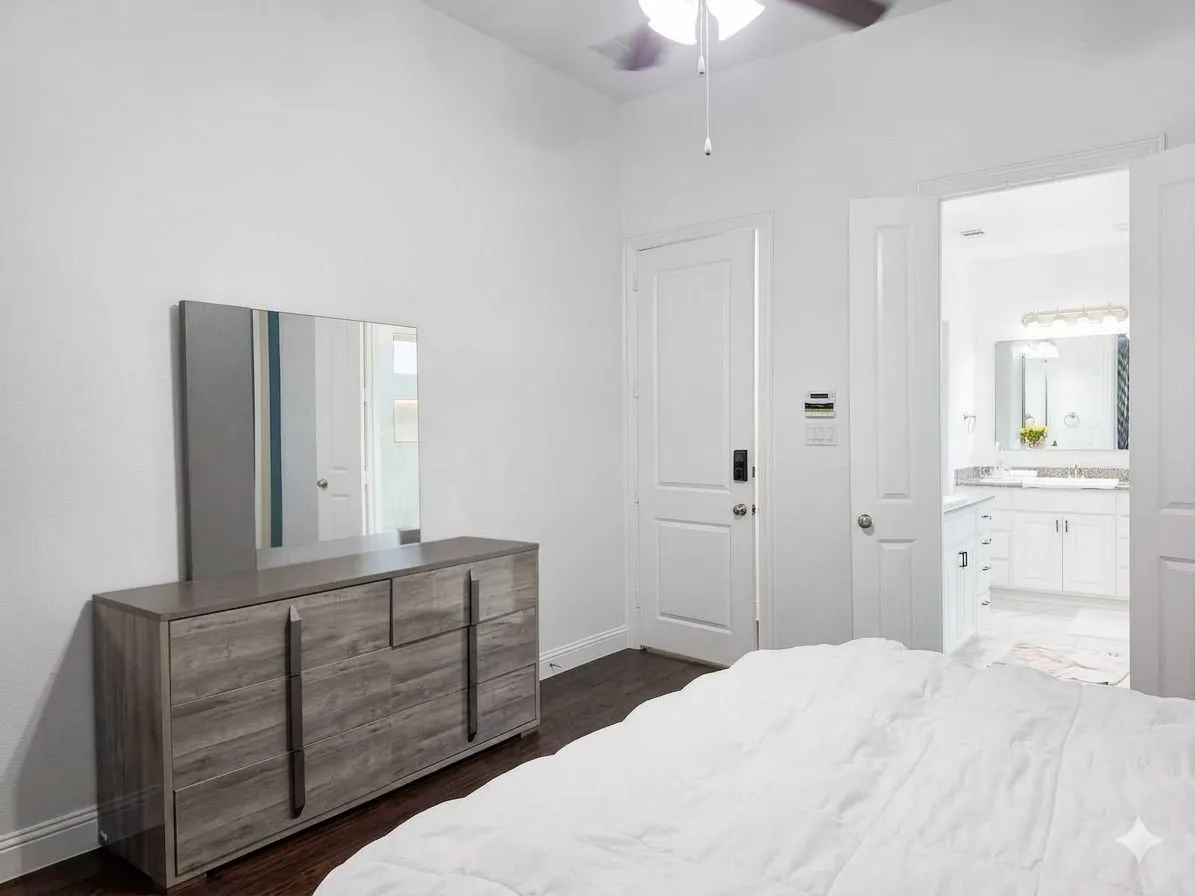 Dark wood-finish flooring with white walls