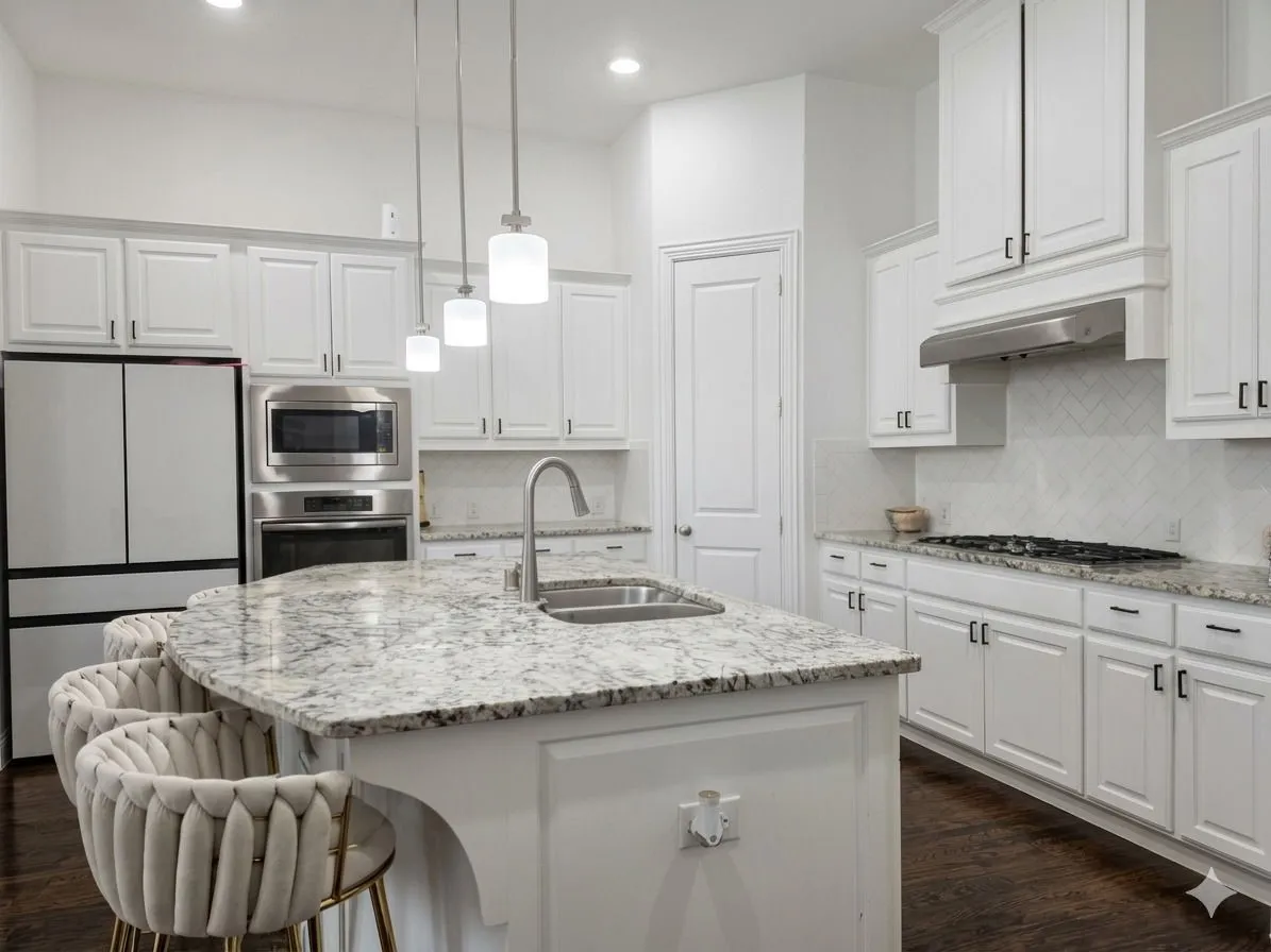 Kitchen featuring an island with a built-in sink, white cabinetry with dark hardware, stainless steel appliances, and wood-finish flooring