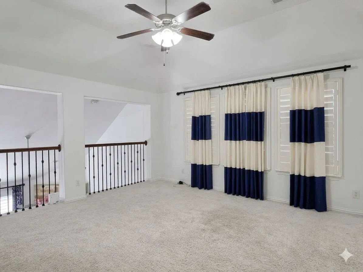 Recessed lighting, ceiling fan with integrated light, carpeted flooring, white walls, and decorative balusters