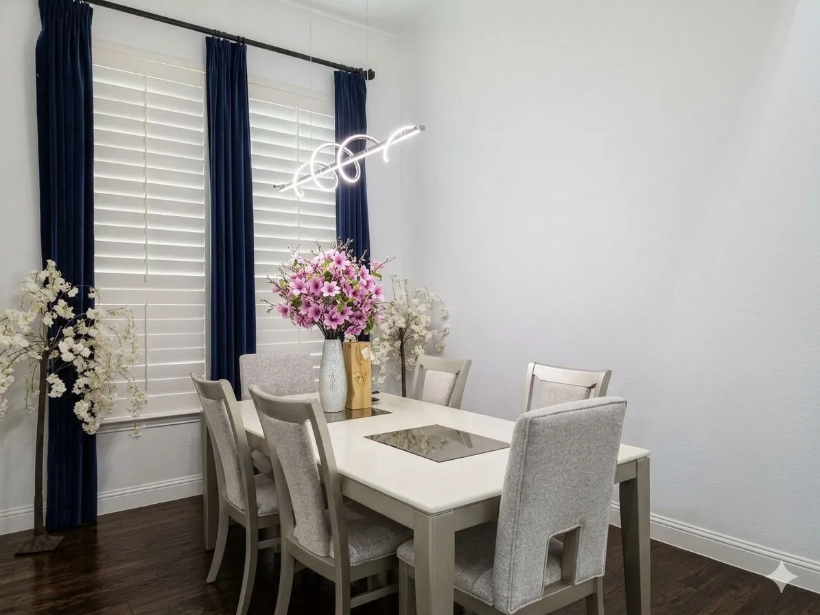 Hardwood flooring, white wall paint, window shutters, blue velvet drapes, and a contemporary linear chandelier
