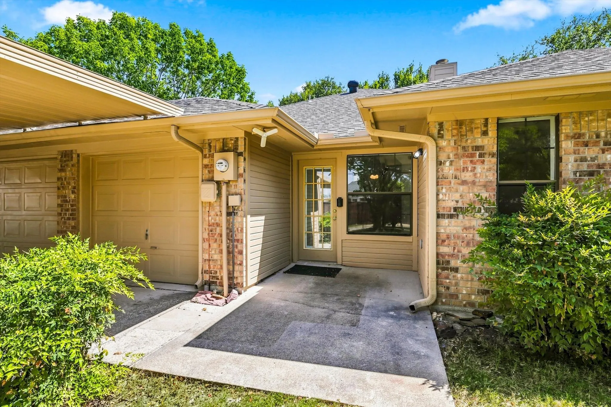 Brick veneer exterior with a covered entry, adjacent to a two-car​​‌​​​​‌​​‌‌​‌‌​​​‌‌​‌​‌​‌​​​‌​​ garage