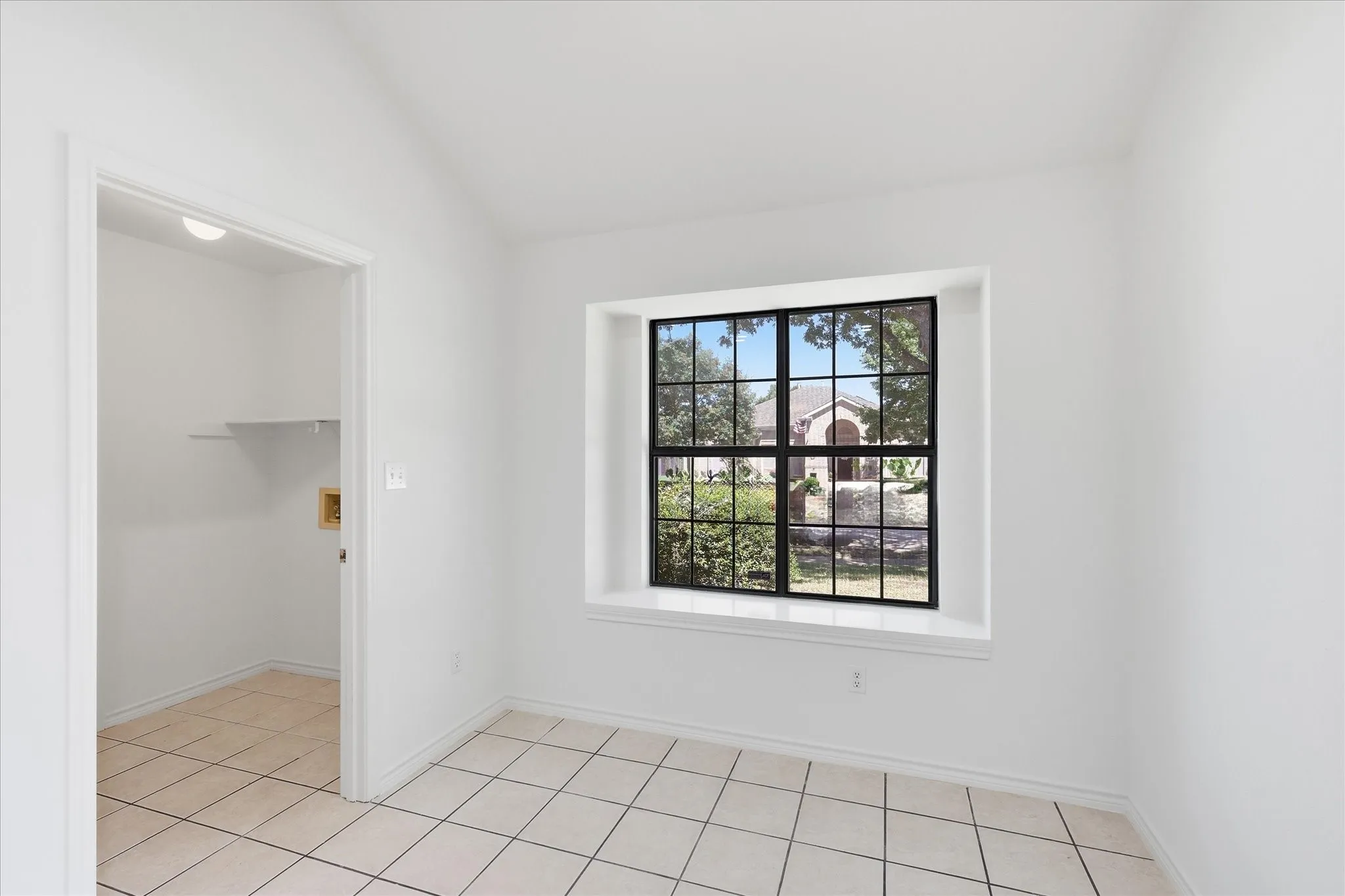 Recessed window with black grid, tiled flooring, built-in shelf, and recessed lighting
