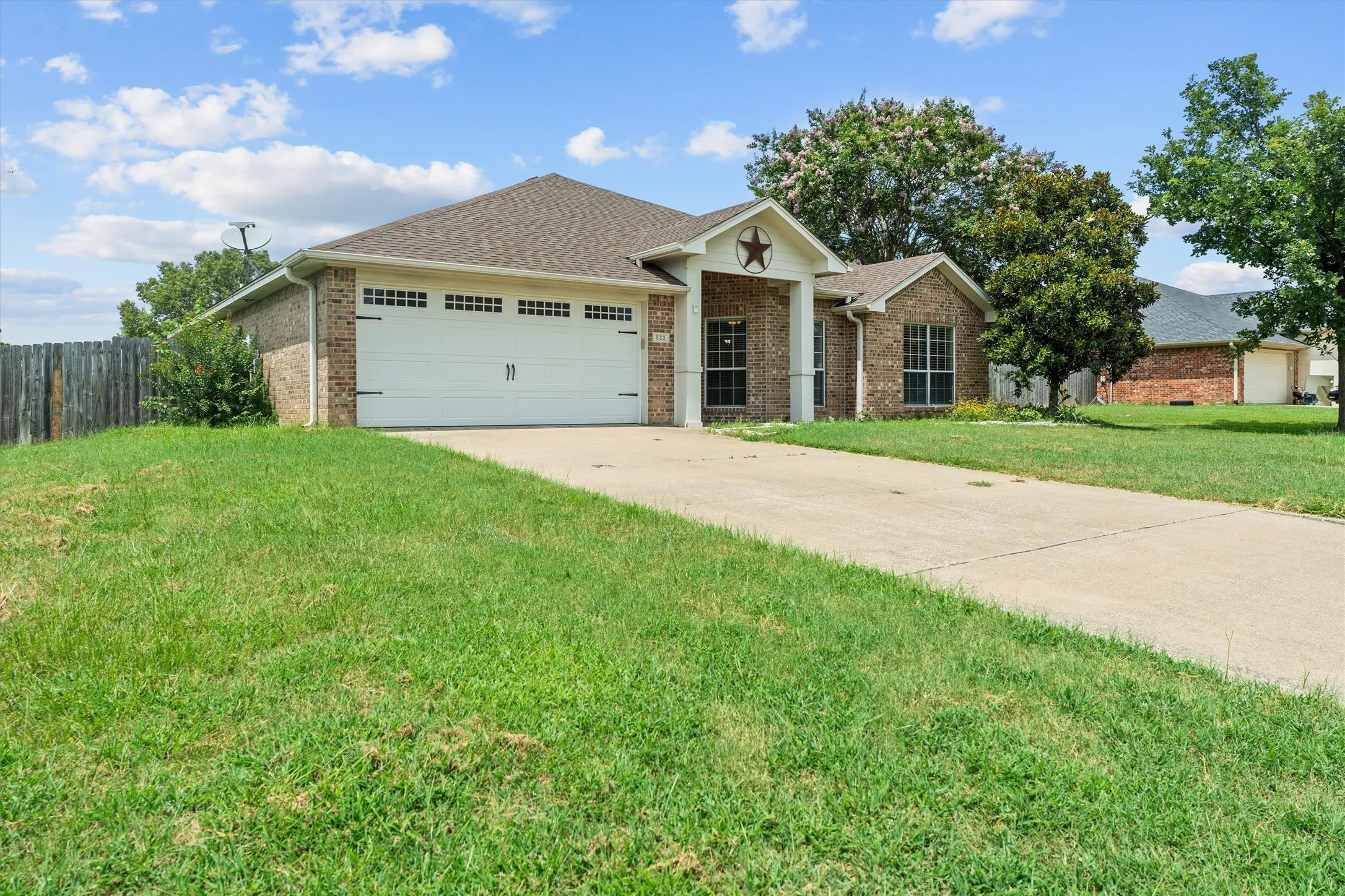 Welcoming brick exterior with arched entryway and decorative star accent