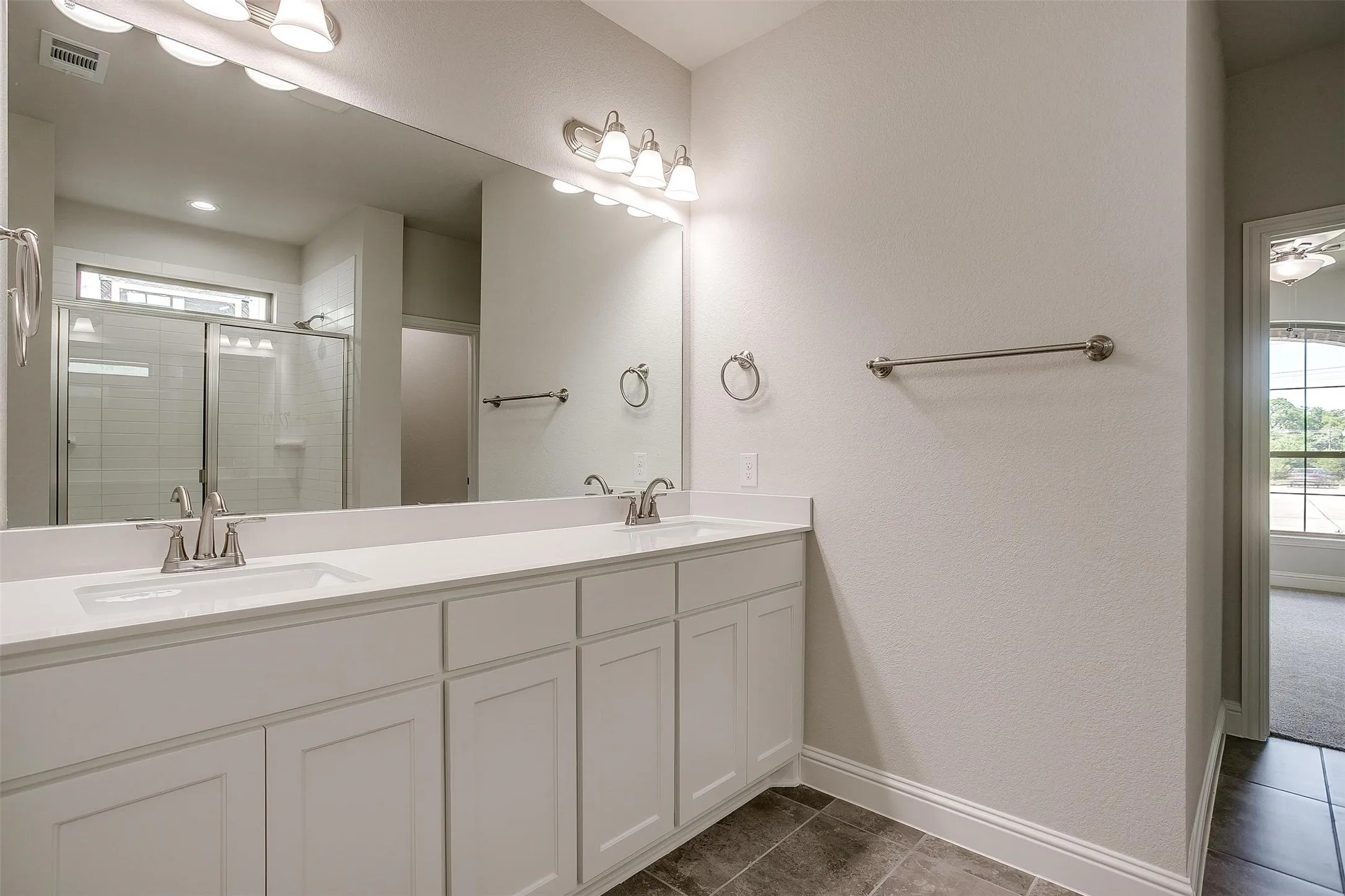 Dual vanity with white cabinetry and integrated sinks