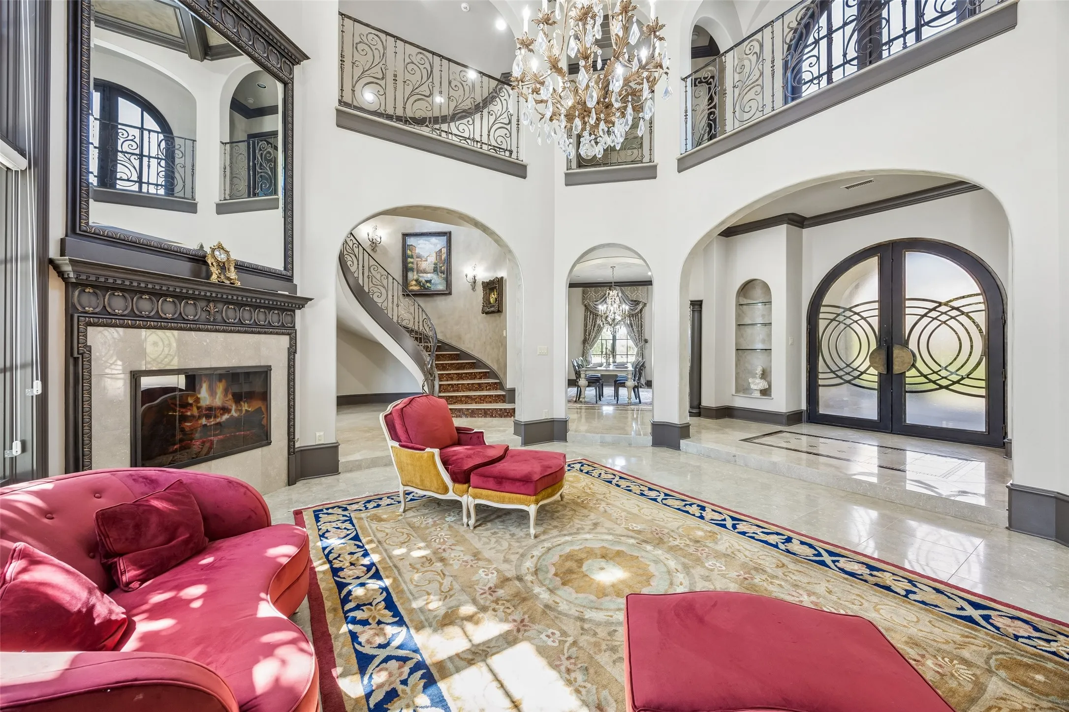 Gorgeous entry foyer and grand living room features a stunning crystal chandelier.