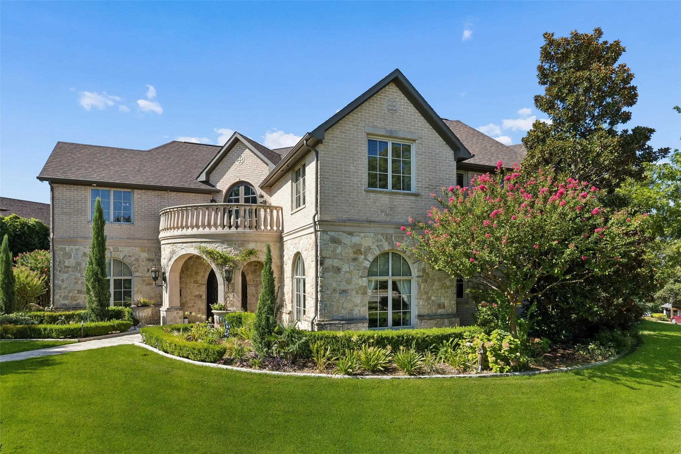 Lush landscaping surrounds the property