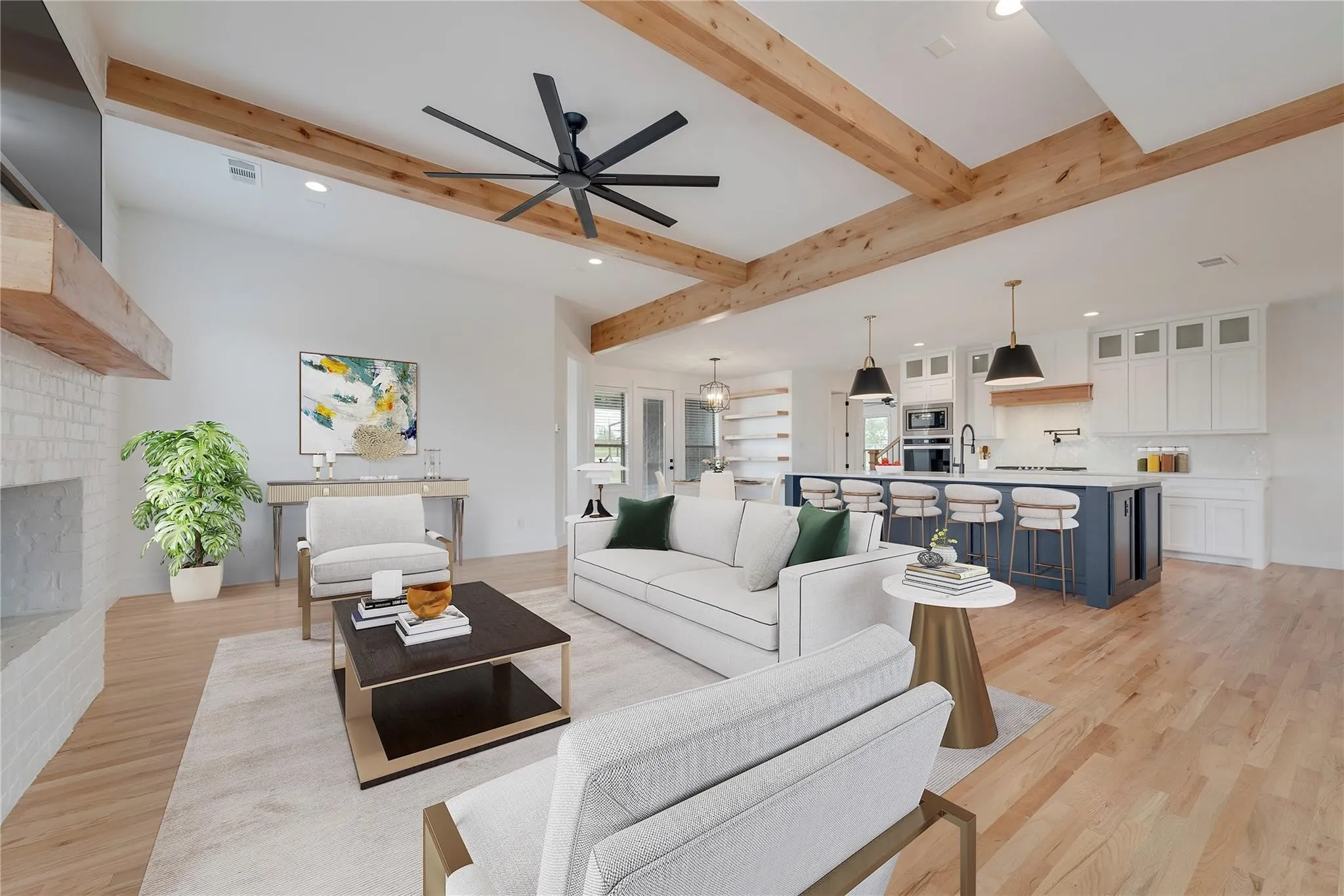 Vaulted ceilings with exposed wood beams define this open-concept living space