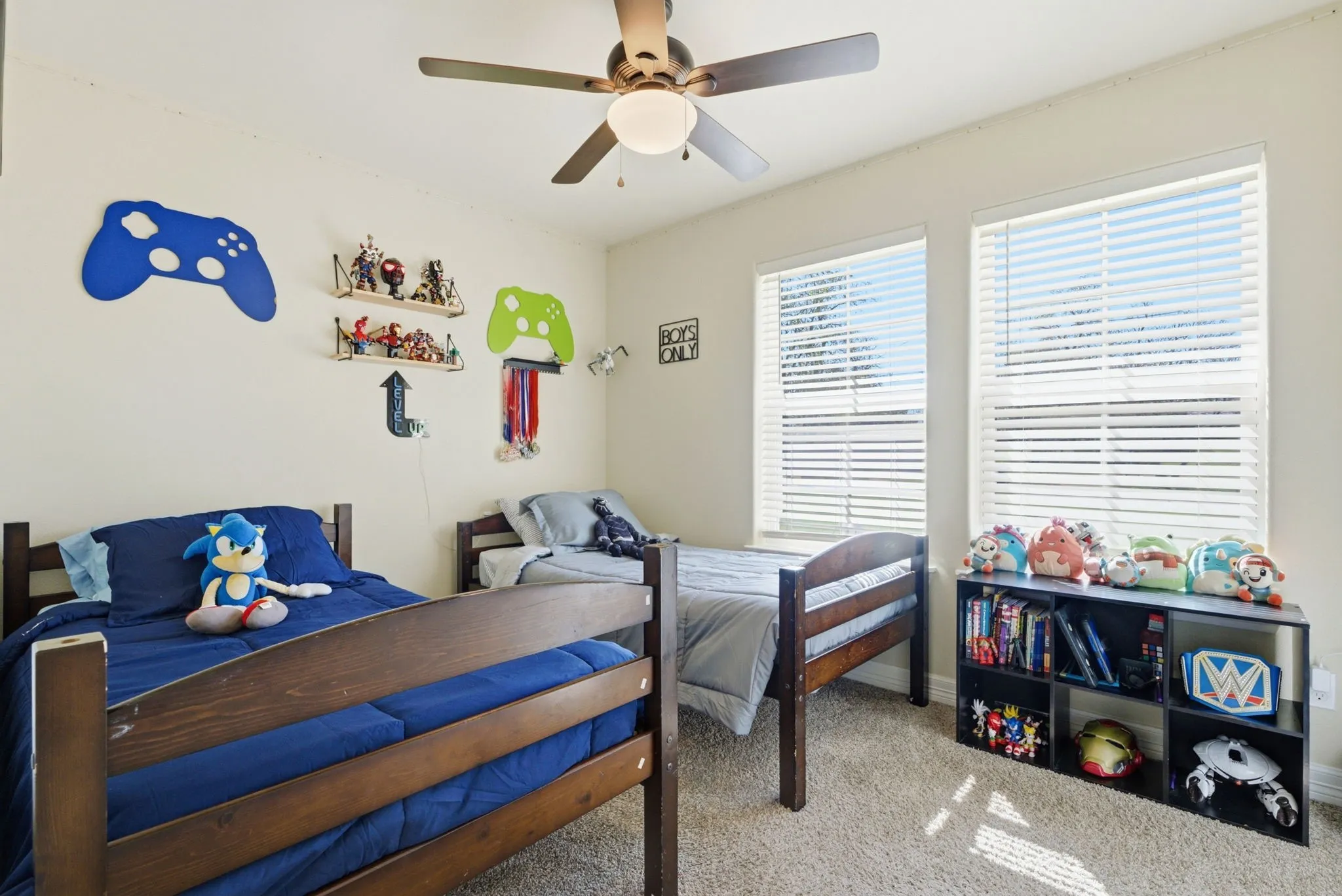 Recessed lighting, ceiling fan, two windows with blinds, and carpeted flooring