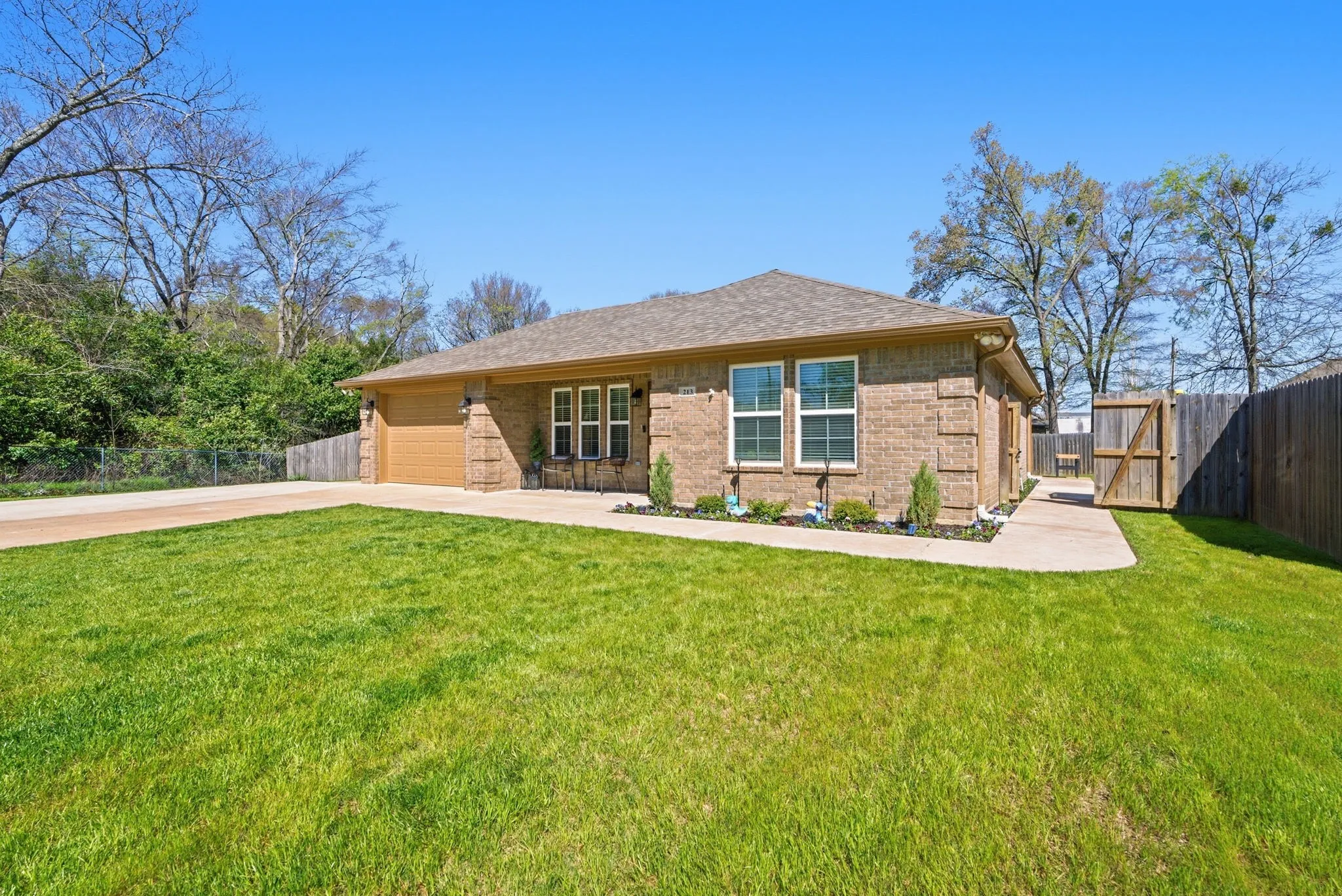 Brick exterior with a gabled roof and attached garage