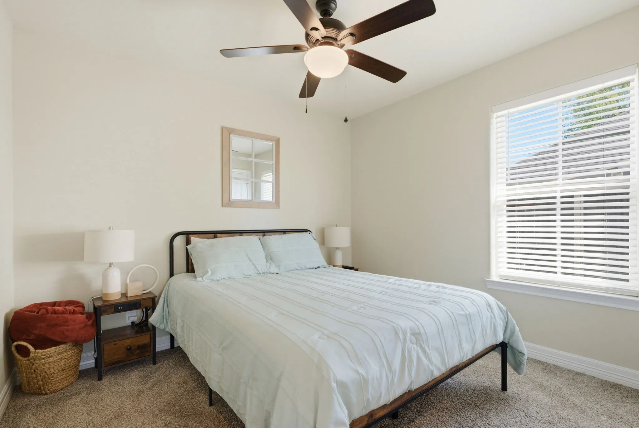 Recessed window with horizontal blinds, ceiling fan with integrated lighting, and carpeted flooring