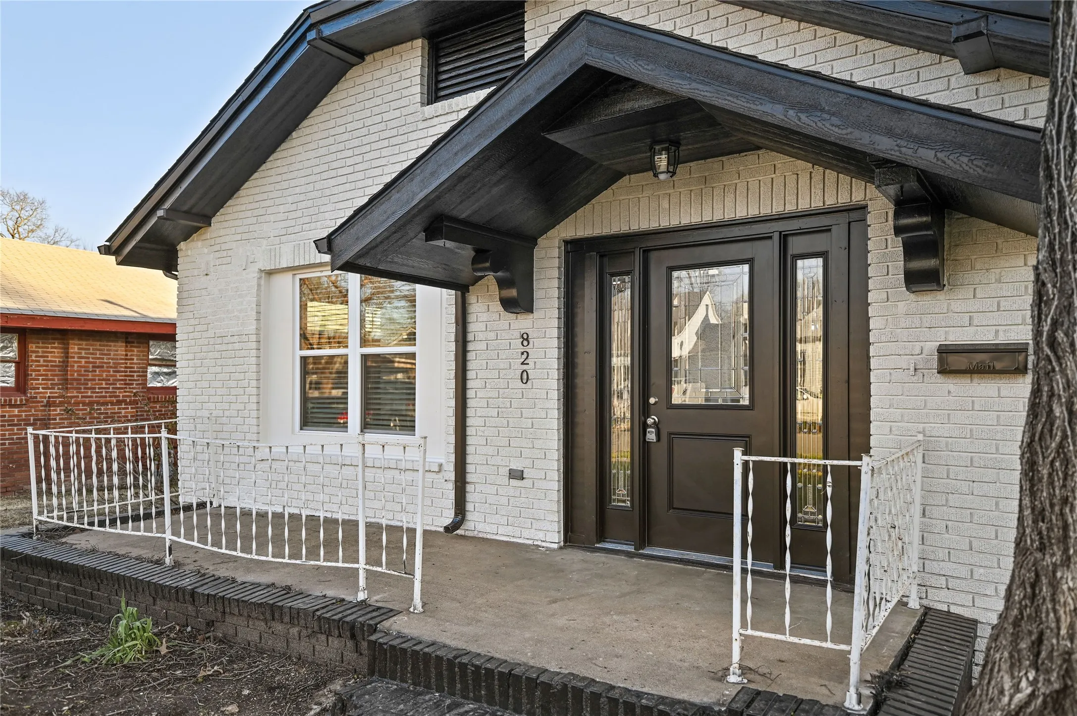 White brick exterior with dark trim accents
