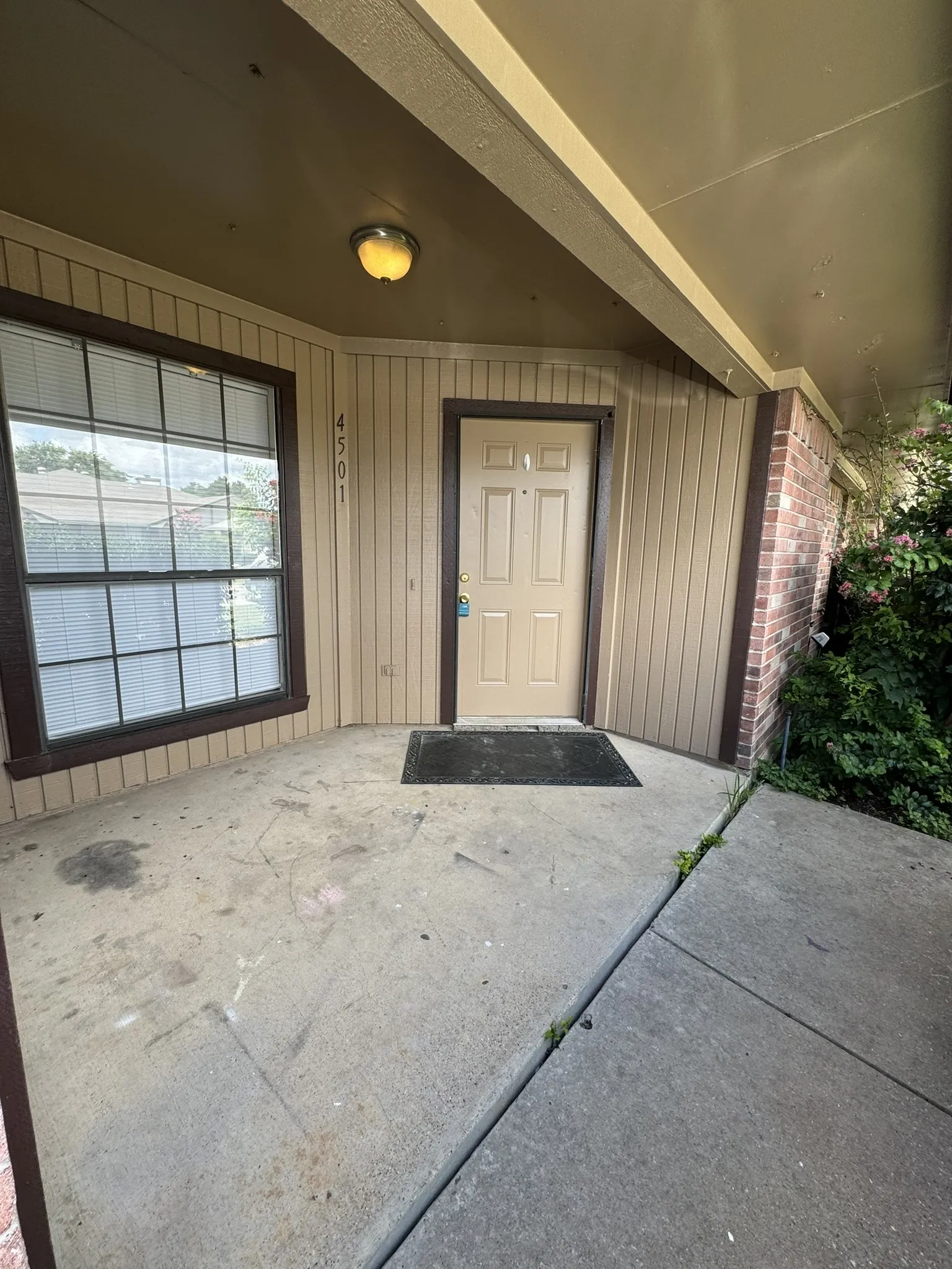 Entry door with panel details and a transom window